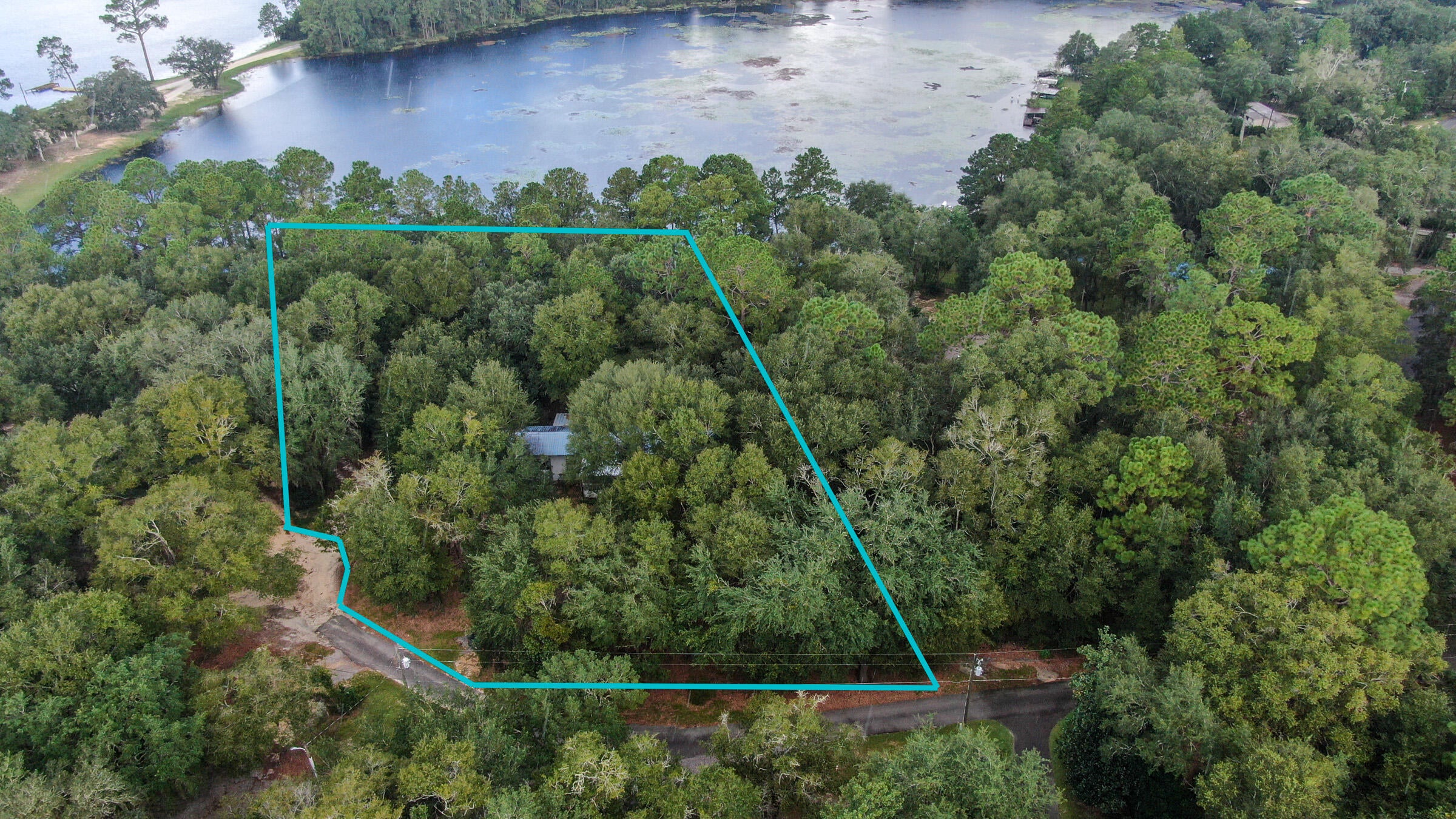 Juniper Lake waterfront fishing camp! Use as a getaway or take advantage of the existing improvements and build your waterfront dream home in this quaint cul-de-sac. Lots of oak trees with shade from the hot summer sun, with the underbrush mostly cleared away. The older mobile home is simple and functional. There's a screened back porch overlooking the back yard and lake. Trophy level bass have been caught, along with bream & crappie, on this 650 acre state-managed and maintained lake. Bonus: there's no HOA. Approximately 40 minutes to the white sand beaches for which Walton County has become famous. Only 10 minutes to downtown historic DeFuniak Springs, voted by MSN online as FL's best small town. It's time to relax, kick back & enjoy the lake life in beautiful Florida. Cash only please.
