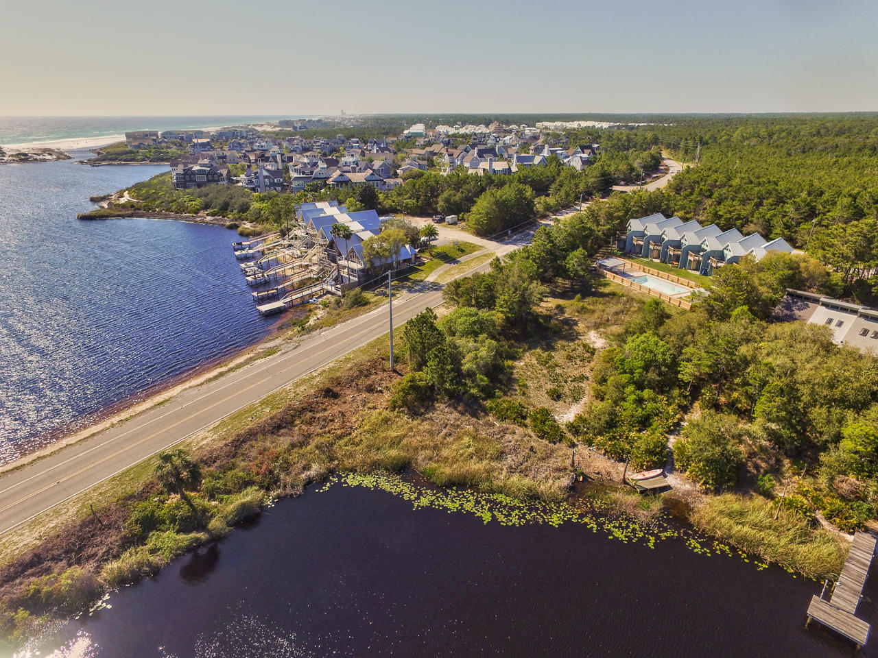 Attention Investors & Developers!! This is your chance to own an income producing, multi-unit property that has 137+ ft of 30A frontage and deeded lake access to Camp Creek Coastal Dune Lake. Seven total units are being sold together. The surrounding common area does not convey with the sale of the townhomes. Units are 2 bedrooms with 2.5 baths and have identical floor plans that consist of approximately 1,300 SqFt. Whether you renovate or redevelop, this property has endless rental potential! Call Erika Monk for details!