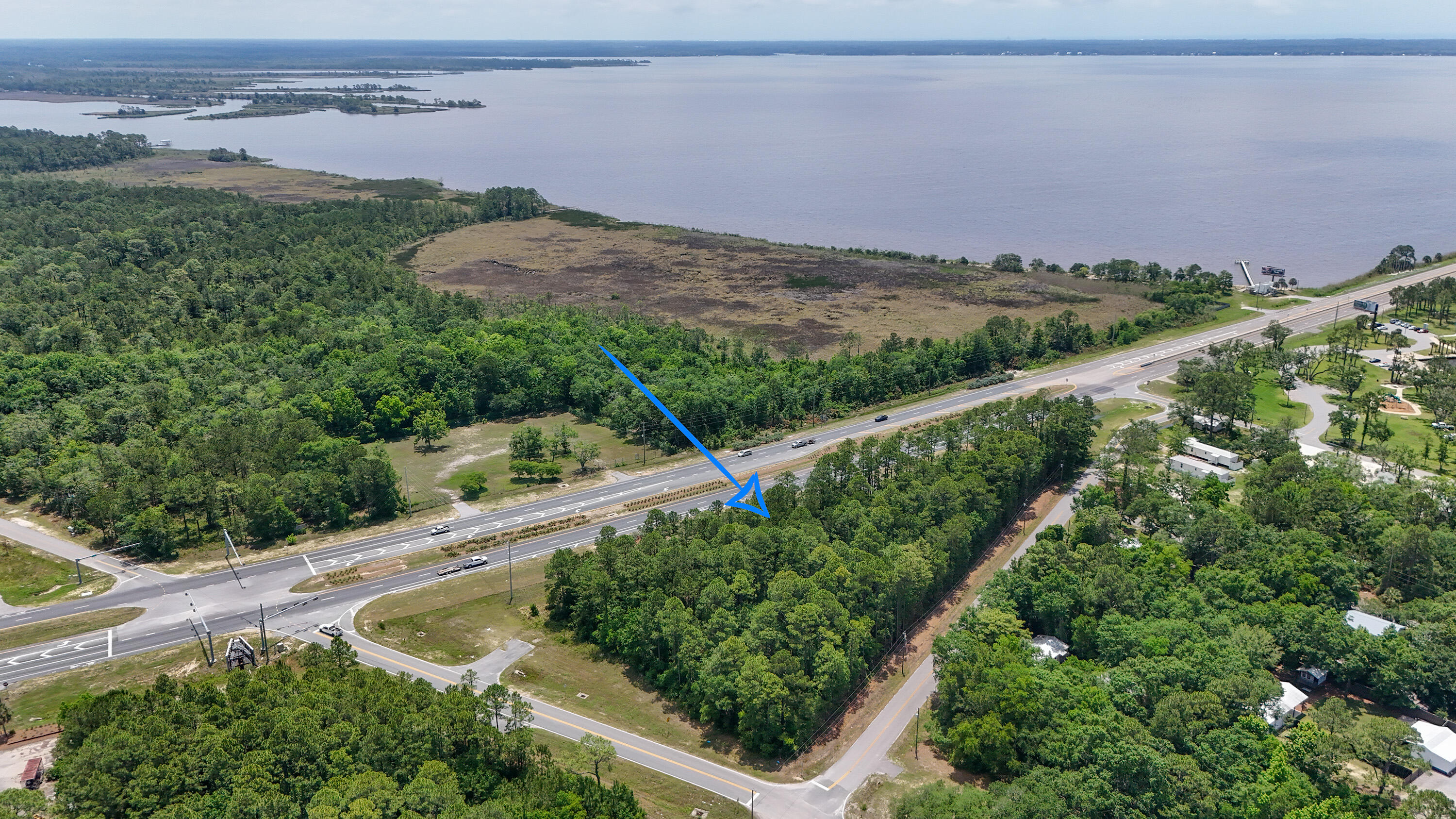 'Gateway to South Walton'. Prime corner location consists of 2.2-acre parcel with 650 feet of highway frontage on 331S just before crossing the 331 Bridge.   The daily FDOT traffic count is 34,000 vehicles. Key infrastructure features include a deceleration lane, signalized intersection, and three paved access points, creating excellent ingress and egress. The property is entirely 'high & dry' and sits adjacent to Grady Brown Park, a public recreational area offering direct access to Choctawhatchee Bay with swimming, fishing, and boat launch facilities. A view of the Bay is possible from the property.  Terrific location for retail, restaurant, motel, convenience store, or similar business where high traffic visibility is important. Location within Freeport's rapidly expanding commercial corridor with major developments recently announced including Walmart, Aldi, WaWa, Chick-fil-A, Holiday Inn, and others.   Survey, Traffic Impact Analysis avail.