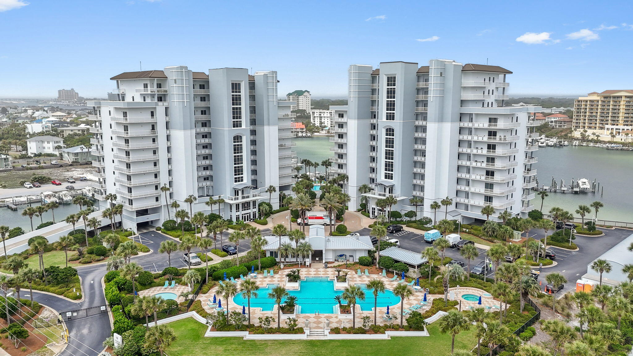 Rare find! Deeded beach access and a private marina waterfront on the Destin Harbor! Come escape to the coveted gated community of Harbor Landing on Holiday Isle. Perfectly located in the heart of Destin, you're just a short stroll from the sugar-white sands, or hop on a water taxi to explore HarborWalk Village along the famous Destin Harbor, Crab Island, or some of the best waterfront dining on the Emerald Coast. Adventure, relaxation, and luxury all await at this spacious 3 bedroom, 3 bathroom condo with over 2,000sqft conveniently located on the second level of the building (the garage is on the first level). With an assigned covered parking spot one floor below, a private exterior storage closet, exclusive deeded beach access right across the street (between Oceania and Martinique), and two sparkling and heated pools (one for owners only!), two hot tubs, fitness center/community room, gas grills, and marina docks (with opportunities to lease slips) and walkways along the water, this condo checks every box for a refined coastal living investment opportunity. The interior of this fully furnished (currently sleeps up to 8 people) and rental ready condo features 8 foot doors, 10 foot ceilings, granite counter tops in the kitchen, tile in the wet areas and new luxury vinyl plank wood flooring throughout, two spacious and private wrap around balconies where you'll enjoy tranquil views of the harbor and a peek of gulf views. The expansive living room is open to the dining area  and kitchen with fantastic views, and the split floor plan offers two oversized bedrooms - one of which is a second master suite with a king sized bed, private bathroom, and private balcony. The other guest bedroom features two full sized beds also with an en suite bathroom. The owner's suite is a spacious room with a gorgeous water view and direct access to the balcony, with a large walk in closet and an en suite bathroom featuring double vanities, a stand up shower, separate jacuzzi style tub, and private water closet. This community is truly in a league of its own! The harbor grants access to the intercoastal waterway and the emerald waters of the gulf of Mexico great for boating and fishing. On your oversized covered patio that covers the length of the condo you'll enjoy spectacular views of the harbor that includes Thursday night fireworks, world class local restaurants, fishing competitions, boat parades and wildlife! Welcome to Harbor Landing 101B.