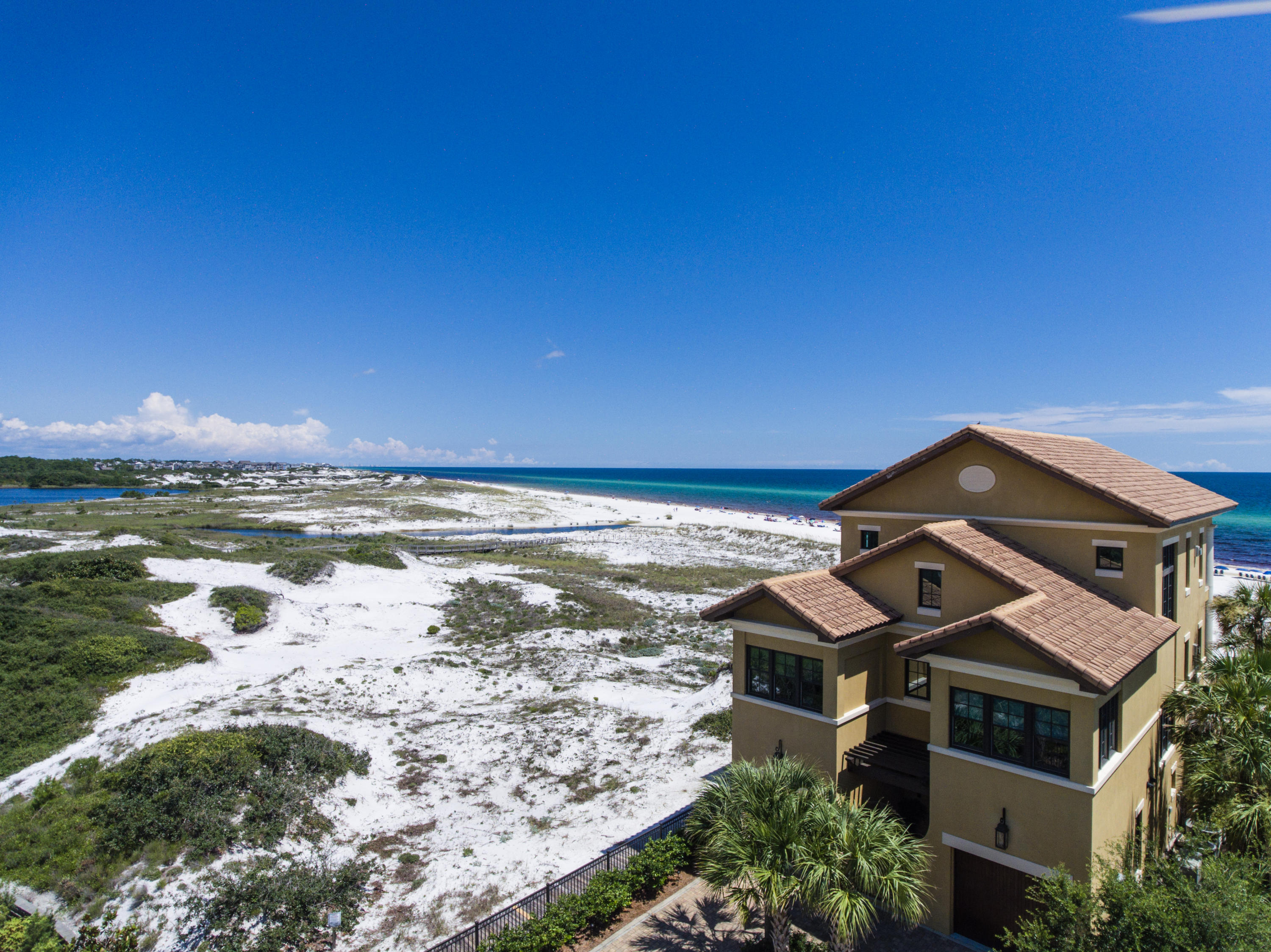 Discover 30A Gulf-front living with unsurpassed privacy and seclusion. 60 Deer Lake Beach Drive is a rare and exceptional Gulf-front estate, boasting 3/4 of an acre with 1.5 miles of open beach to the east for the ultimate privacy. This beach estate provides serenity like no other. An extraordinary location bordering award-winning Deer Lake State Park, offering approximately one and a half miles of unobstructed Gulf views to the east overlooking the coastal dune lake of Deer Lake all the way to WaterSound Beach. Deer Lake State Park sits as your direct eastern border neighbor, occupying one half mile of Gulf frontage that will never be built upon and the full mile of private community beach of WaterSound Beach follows. The custom-built beach home was designed by renowned architect Walt Chancey and constructed by the notable firm Regal Stephens Construction.   Prominently situated as the most private end lot in the exclusive low-density, 6 home site community of Deer Lake Dunes . This unique parcel boasts ~51 feet of Gulf frontage and an impressive lot depth of 580 feet deep, totaling 3/4 of an acre. Exceptional views from nearly every room!  This custom home was built with the mindset of truly enjoying coastal living. The home is solid concrete with deep pilings ~35 ft. in the ground, synthetic decking, and hurricane-rated windows, lending low maintenance for Gulf front living. The pride of ownership is apparent the moment you step foot on the grounds. The home is offered unfurnished, though the inclusion is negotiable.  
With plentiful outdoor space, including three expansive Gulf-front decks and an easterly grilling patio, and an open floor plan commanding panoramic Gulf views, this home is perfect for entertaining.  The home is 3-stories with luxurious finishes throughout. The ground level offers two Gulf-front guest rooms, each with en-suite bathrooms, and a Gulf-front lounge area, all with direct access to the deck.  Easily exit to the large sun deck along the Gulf-front to enjoy the beach and an upscale fire pit.  The addition of a pool is an easy option, see the included rendering.  Stunning archways capture the picturesque Gulf views. There is also a laundry room with marble countertops, storage and access to the outdoor shower, which is aligned next to the Deer Lake Dunes boardwalk for easy beach access! The welcoming foyer houses an elevator which accesses all three levels. 
The second level features an open living & dining area, with glass spanning across the entire length of the home along with wrap-around windows to the east for panoramic views of the Gulf and Deer Lake State Park. Access an incredible Gulf-front terrace and enjoy outdoor dining to a cool beach breeze, or relax in one of the rocker chairs while taking in views. Interior features include 10 foot ceilings, recessed lighting & surround sound, custom beamed ceilings, crown molding, built-in shelving and gas fireplace. The kitchen boasts an impressive view corridor and features custom cabinetry with antique mirrored glass and hardwood, a farmhouse-style sink and island complete with gas cooktop and custom hood. There are granite countertops & breakfast bar, ice machine, refrigerated drawers and a large walk-in pantry. The breakfast bar is perfect for more casual dining but there is a dining area for eight surrounded by glass and exceptional views. Also located on the second level are two additional guest rooms, one with en-suite bathroom & walk-in closet, a powder room and additional balcony off the kitchen facing east. 
The entire upper level is the master quarters, featuring a stunning Gulf-front suite & bathroom, exercise room, additional laundry room and morning kitchen. The master suite is complete with a gas fireplace and sitting area, and direct access to the private terrace. The en-suite bathroom is phenomenal with a gorgeous soaking tub, double vanities, a separate walk-in shower and endless views of the Gulf and Deer Lake State Park. Feel like you are at the spa and unwind in luxury. 
This is truly a one-of-a-kind Gulf-front property, a rare gem with its special location adjacent to preserve lands.  The community of Deer Lake Dunes is nestled in a prime 30A location in Seagrove, east of Seaside and just west of WaterSound Beach, Alys Beach, and Rosemary Beach. The exceptional location  provides matchless seclusion while remaining in close proximity to the bustling 30A communities and award-winning restaurants, local shops & art galleries, and entertainment.  Seaside is close by, with eclectic airstream food trucks, an amphitheater, farmer's markets, Modica Market, Amavida coffee shop and more. If you prefer to explore nature, just stay in the community and have a picnic at Deer Lake State Park, hike or bike the nature trails or paddle board the coastal dune lakes. You have the private and relaxing environment you have been looking for with just a quick drive to the action. Discover a special opportunity to own your dream home in one of 30-A's most exclusive communities.