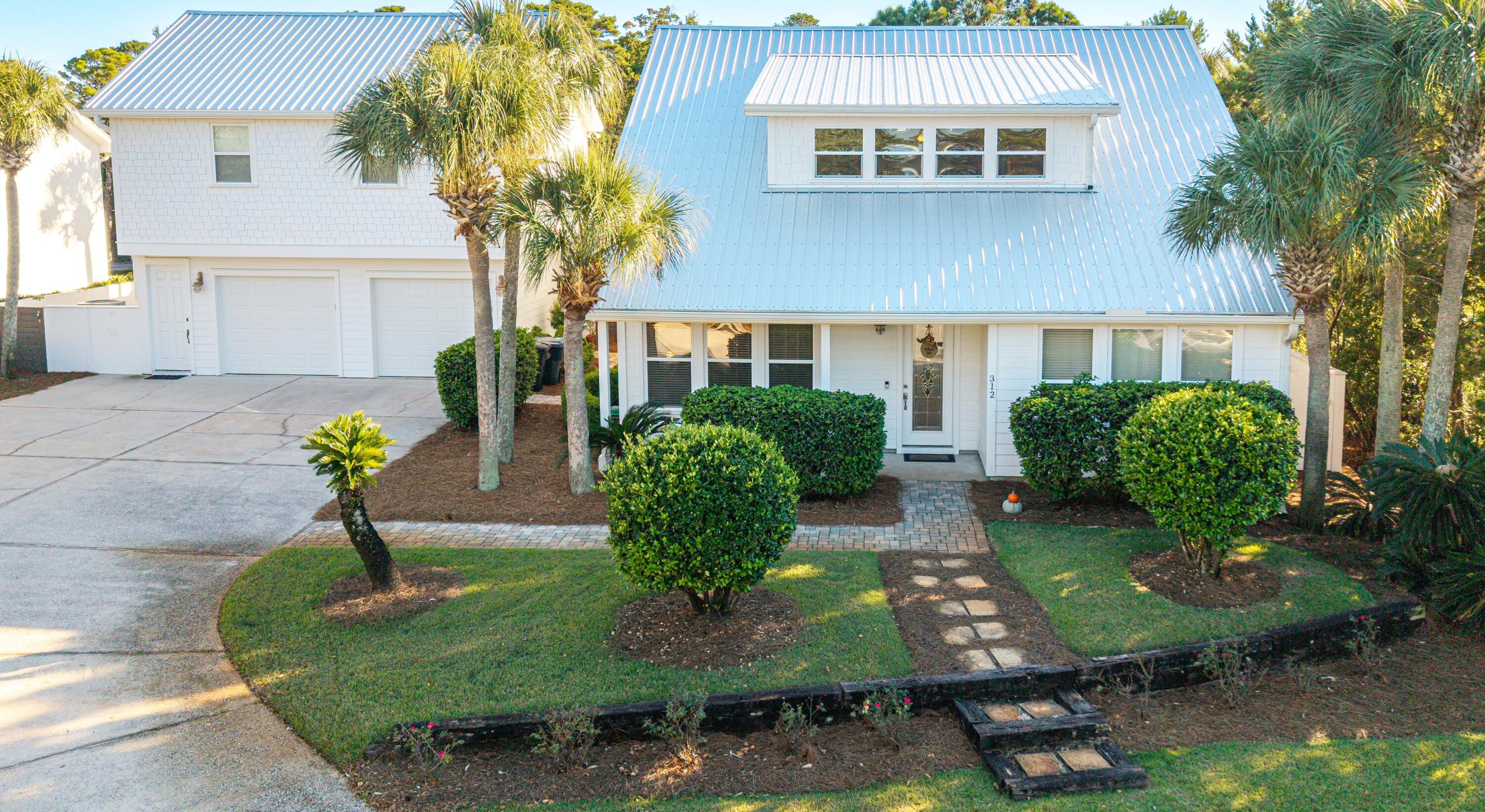 Welcome to your perfect beachside retreat — a captivating 5-bedroom, 4.5-bath golfer's sanctuary offering 3500 square feet of sunlit, coastal elegance. Ideally located just steps from the Santa Rosa Golf & Beach Club and only minutes from the pristine, sugar-white sands of Dune Allen Beach, this home perfectly blends relaxation, recreation, and refined living. Step inside to discover an airy, open-concept layout filled with natural light featuring a chef-inspired kitchen with sleek quartz countertops — ideal for entertaining after a day at the beach or on the greens. The main-level primary suite offers a tranquil retreat with easy access to outdoor living.
Outside, your private backyard oasis awaits — centered around a resort-style 20'x60' heated pool, perfect for lounging  or hosting unforgettable outdoor gatherings with family or friends. Tucked above the detached two- car garage, a 728 sq ft guest casita with a full kitchen, bedroom, and bath provides the perfect space for visitors or extended family.  Whether you're seeking a full-time residence, a vacation escape, or a smart investment, this home offers the ultimate coastal lifestyle convenient to golf, beach, and all that Santa Rosa Beach has to offer.