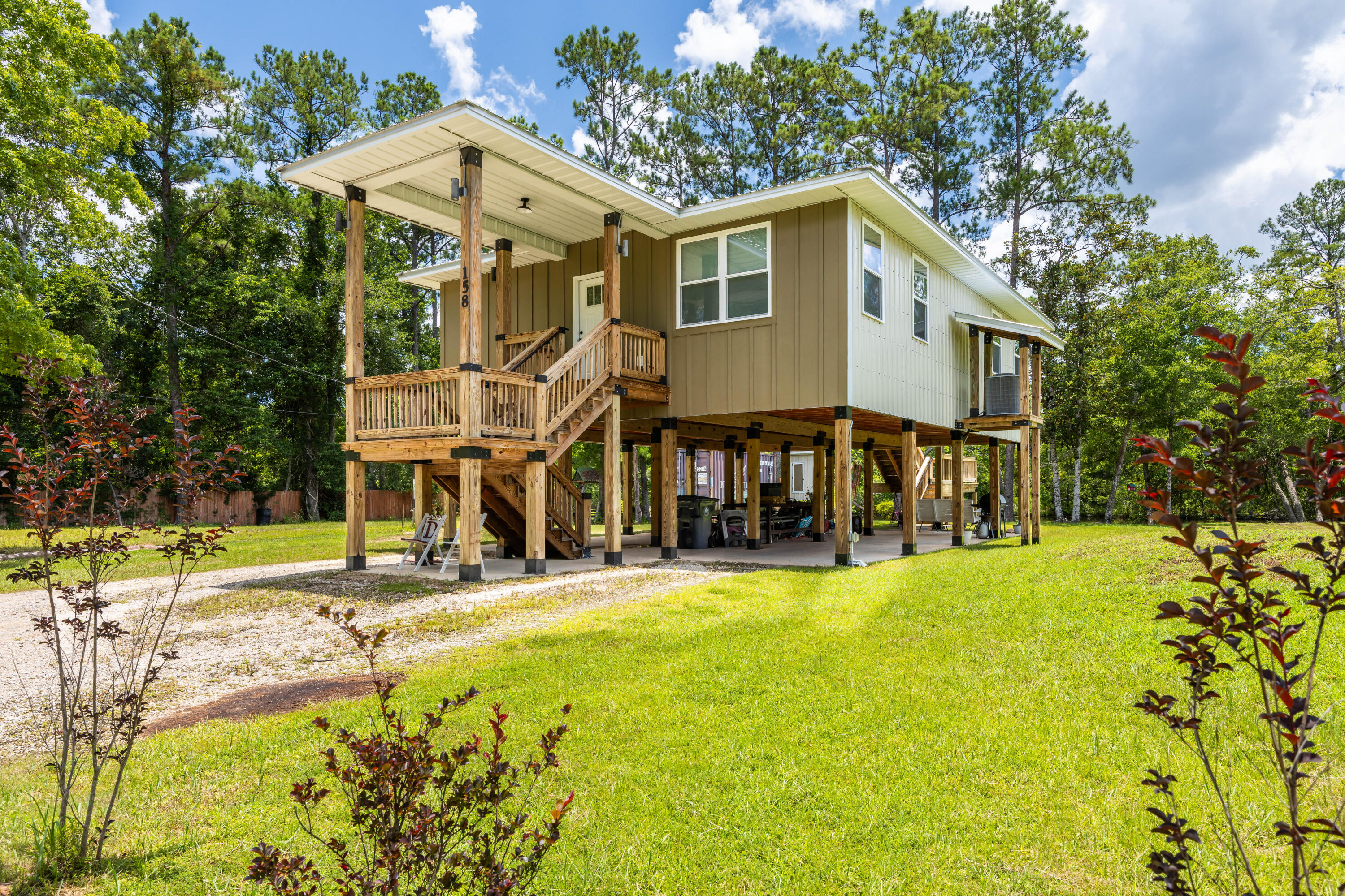 HUGE PRICE IMPROVEMENT-SAME WATER VIEWS!
Owner Builder, Custom Built - Waterfront Florida Cottage on Alaqua Creek.

Qualifies for 100% USDA Financing!
This MUST SEE one-of-a-kind, custom waterfront home, designed by Designs by Vision, showcases exceptional craftsmanship and innovation. It features the patented Ty-Rite System, a revolutionary piling installation method where no wood touches the ground, ensuring superior durability and longevity. This system makes this home stronger than any other wood-pile waterfront home in the area! The home is elevated on wood pilings with a solid concrete foundation, enhancing flood protection, promoting air circulation beneath the structure, and significantly reducing long-term maintenance costs. The elevation also provides ample space to store a 20' boat and park up to four vehicles Enjoy stunning views of Alaqua Creek from the spacious 10' x 20' covered porch, complete with custom steel-capped handrails. Inside, the open-concept living and kitchen area with an island offers incredible waterfront views. and is outfitted with custom solid wood cabinetry built from ¾ inch poplar wood, finished with crown molding. The kitchen features 1.5" thick granite countertops, a large island, 9' ceilings with crown molding, waterproof vinyl wood flooring throughout, LED lighting, and Whirlpool appliances. The home is equipped with a 2 Ton Carrier HVAC system with heat pump (14 SEER) for year-round comfort. 

Bathrooms include custom solid wood vanities, granite countertops, and ceramic tile flooring. Exterior features include Hardy board front siding, 29-gauge steel metal roofing and siding, a mound septic system, and a 4" well with two advanced filtration systems to ensure clean, safe water. The home is also pre-plumbed for an outdoor shower, perfect for rinsing off after fishing or watersports days or gardening. Recently pressure washed, the home is designed for low maintenance and watertight performance. 

Affordable home on deep water that goes out to the Bay! Located near the Alaqua Creek Park Public Boat Launch, this property offers direct and quick access to Choctawhatchee Bay.  No comparable homes in the area for this price. Homeowners and Flood insurance is very affordable, and utility bills remain low! 

 Best of all, there are no HOA fees or restrictions