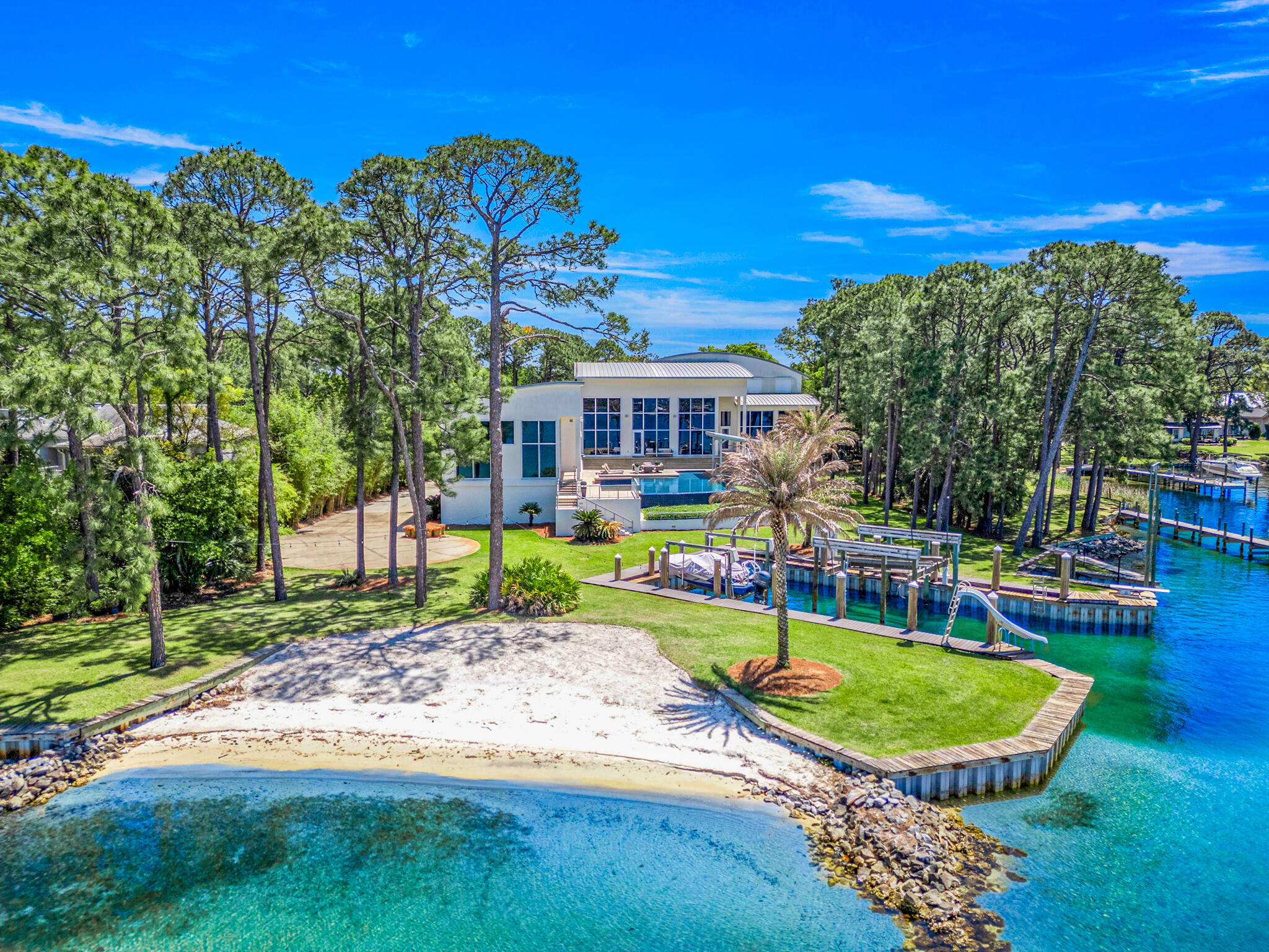 Worldbid Auction - Qualifying round sealed bids due no later than July 15 th Noon 2025CT. Bidders
within the top 50% by price will be notified to submit the Final sealed bid on July 15 th 3pm CT 2025 and
their Final bid is due no later than July 16th Noon CT 2025. The Successful Bider will be notified on July
16 th 2025 no later than 3pm they have been awarded the Property. Buyer's may obtain financing, though
financing is not a contingency to close. Proof of funds to close and/or a lender's approval letter are
required with your bid. You may conduct your inspections anytime.

Uncover Florida's Ultimate Luxury Waterfront Escape! Imagine waking up to your private beach, gazing over an infinity pool that melts into sunset views, and stepping onto your yacht from a private harbor. This expansive, modern mansion near Destin, FL, offers an elite sanctuary with every detail crafted for indulgent living and effortless entertaining in un-paralleled convenience and privacy.

Step off the plane at either the private or public airports, and within 10-20 minutes, be on your private beach or setting sail or enjoying a game of indoor tennis or bowling. This is the ultimate luxury for the discerning person who has the need to make the most of every minute away from the rigors of life and still be able to create indelible memories and a lasting legacy with loved ones at an estate that was intentionally created for those forever moments. 

Situated on close to 2 acres, this spectacular, gated, modern estate is extremely private and contains all of the amenities and entertainment that you would want for your family and guests to enjoy at your Floridian paradise. The residence is over 7K square feet featuring an expansive living room with soaring ceilings and an unparalleled master suite. Additionally, there is an 8K square feet of recreational space for all of your memories to be made or converted to other uses. For the yachtsman, the cut-in harbor is 32x70 and can easily accommodate most large and small yachts, speed boats and more. Need space for a 100ft or more yacht? Not a problem, a large dock is able to be permitted and constructed off the point giving a large yacht 15-20ft of depth and year-round protected waters.

With full size tennis/basketball courts, incredible infinity pool, bowling alley, batting cage, movie theater, 6 car garage, private white sand beach and thousands of square feet of additional storage or expansion space, this estate truly has all the accoutrements you would want for an exclusive second home or exquisite primary residence.