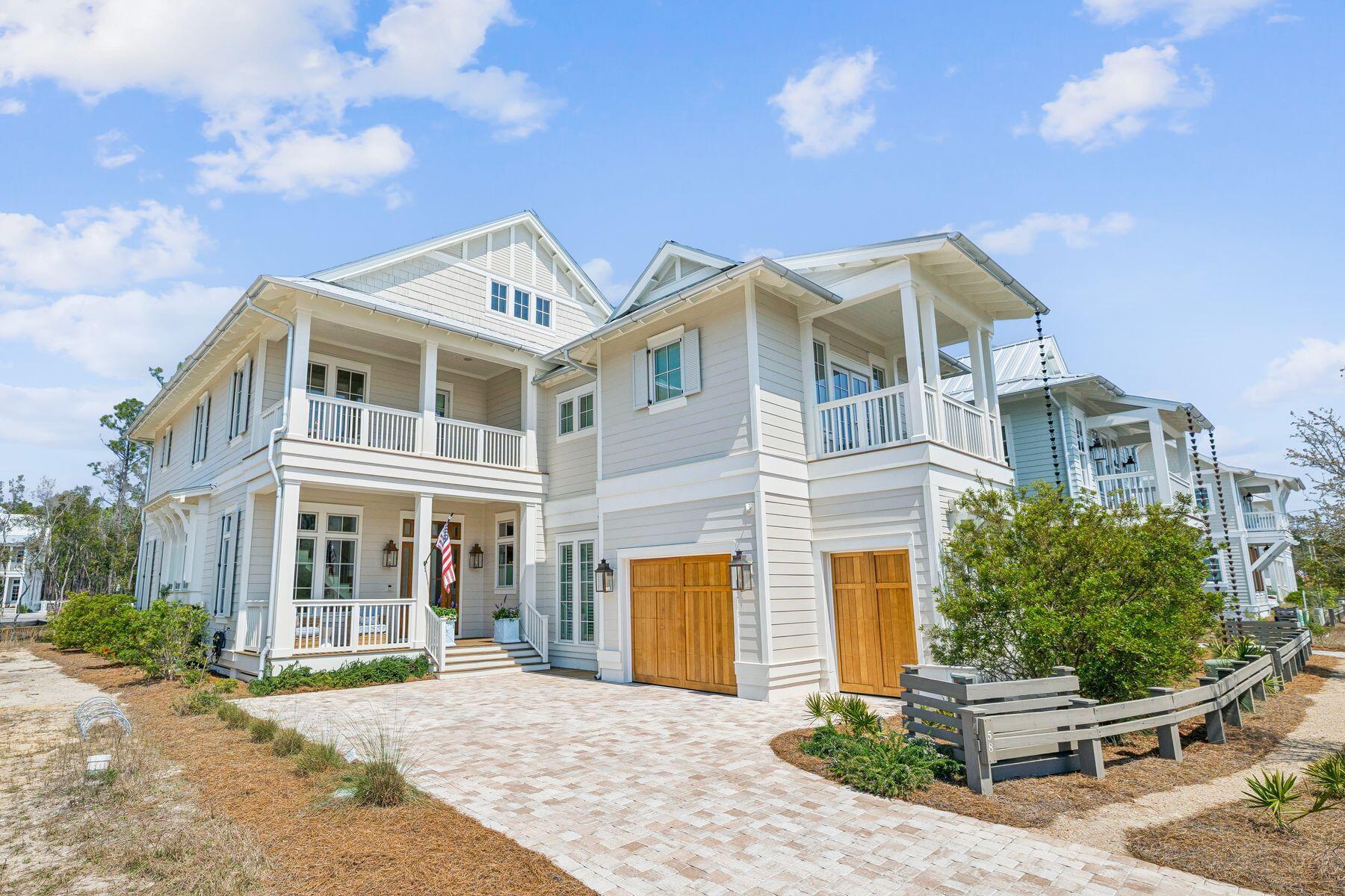 Situated within WaterColor's only non Short term rental and newest--and quickly become most coveted--setting, this gracefully designed residence captures the very essence of refined coastal living.There is a quiet confidence to this WaterColor home, the kind that comes from vision carried through without compromise. Never before offered, it arrives fully realized -- an extraordinary collaboration between architect Greg Jazayeri, builder Borges Brooks, and the discerning eye of Kaitlyn Tiller of Kalon Home. The result is a residence that feels at once elevated and deeply livable, where every detail has been considered and nothing left to chance.

Inside, volume and light set the tone. Soaring cathedral ceilings with exposed beams rise more than 20 feet above...  ... the main living spaces, creating.. airy sense of scale, while ... hardwoods ground the home in comfort. The open living, dining, and kitchen areas unfold with ease, designed as much for quiet mornings as they are for lively evenings. A Sub-Zero refrigerator and Wolf range anchor the kitchen, complemented by custom Smithart cabinetry and a discreet butler's pantry that brings both function and refinement to entertaining.

The living room flows seamlessly to a screened porch where a second fireplace and outdoor grill extend the experience outdoors, offering a natural gathering place in every season. Nearby, a custom bar invites conversation, while curated furnishings, designer fabrics, and custom drapery throughout the home lend a sense of cohesion and polish that is immediately felt but never overstated.

Each bedroom is appointed as a private suite, offering both comfort and privacy, with oversized closets thoughtfully designed for flexibility -- even a crib when needed. Upstairs, the home takes on a more relaxed rhythm, with two inviting porches and a generous family game room that creates space for connection, retreat, and play. A bunk room with a king bed below adds both charm and versatility for guests of all ages.

Moments of artistry are woven throughout. A Pierre Frey wall covering elevates the powder bath into something memorable, while Schumacher fabrics, Serena and Lily accents, and custom stairwell art contribute to a layered and collected aesthetic. Even the unseen details speak to the home's level of care, including a whole-house water purification system with demineralization at the kitchen faucetl an uncommon feature that reflects a commitment to wellness as much as design.

Set within one of the area's most sought-after settings, the home offers access to an exceptional collection of amenities, including multiple resort-style pools, miles of walking and biking trails, tennis and pickleball courts, a new fitness center underway, and a vibrant mix of shops, dining, and outdoor recreation.

This is a home that doesn't rely on a single moment to impress. Instead, it reveals itself gradually, through craftsmanship, materiality, and an unmistakable sense of intention--an enduring expression of coastal living at its most refined.