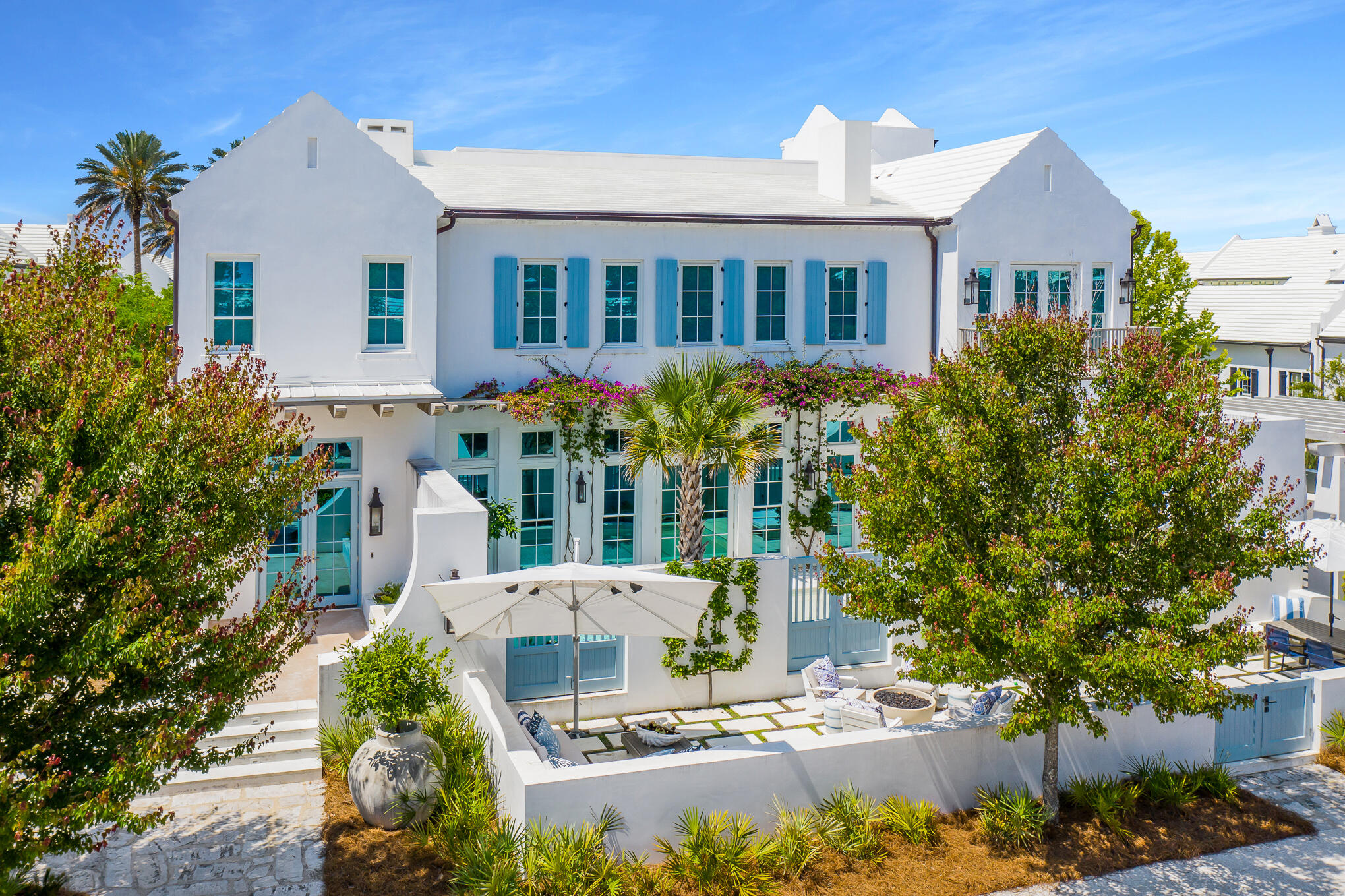 RECORD HIGHEST PRICE PER SQ FT OF ANY HOME SALE ON NORTH SIDE ALYS BEACH. Poised prominently on a corner site along the pedestrian path, this Alys Beach residence presents sophisticated luxury living on the coast. Aptly named ''Bougainvillea'' for the brightly colored flowers that charmingly adorn the front side of the house, the residence was designed by renowned architect David Stocker of SHM Architects. A spacious open design with high ceilings & walls of windows give way to an abundance of natural light. The main floor features a spacious living area & a fully appointed chef's kitchen & elegant dining area. Also conveniently located on the first floor is a guest bedroom with full bath. The second floor hosts a comfortable flex space room, the master suite, and two additional guest suites, all with en suite bathroom. The stunning master suite features  fireplace & sitting area, vaulted ceilings, & tall windows with French doors leading to the private balcony overlooking the pool & courtyard.  The master bath includes both a soaking tub & separate shower, along with double vanity & custom tile. One of the guest rooms houses custom built-in bunks, a set of twin bunks as well as a set of queen bunks, allowing for plenty of room for guests. The additional guest room offers a king size bed, vaulted ceiling, & tall windows with front facing views. The cozy flex space media room features a wet bar & is a great place to curl up & unwind after a long day on the beach. Step outside to take in the private oasis of the extensive outdoor living space. Take a dip in the private heated pool or simply relax in the sun while lounging. The summer kitchen provides a wonderful space to cook & dine al fresco. A tranquil & private courtyard setting complete with firepit & enough seating to entertain & relax with family and friends. The home creates an ideal indoor/outdoor living space that is a lifestyle theme of Alys Beach.
