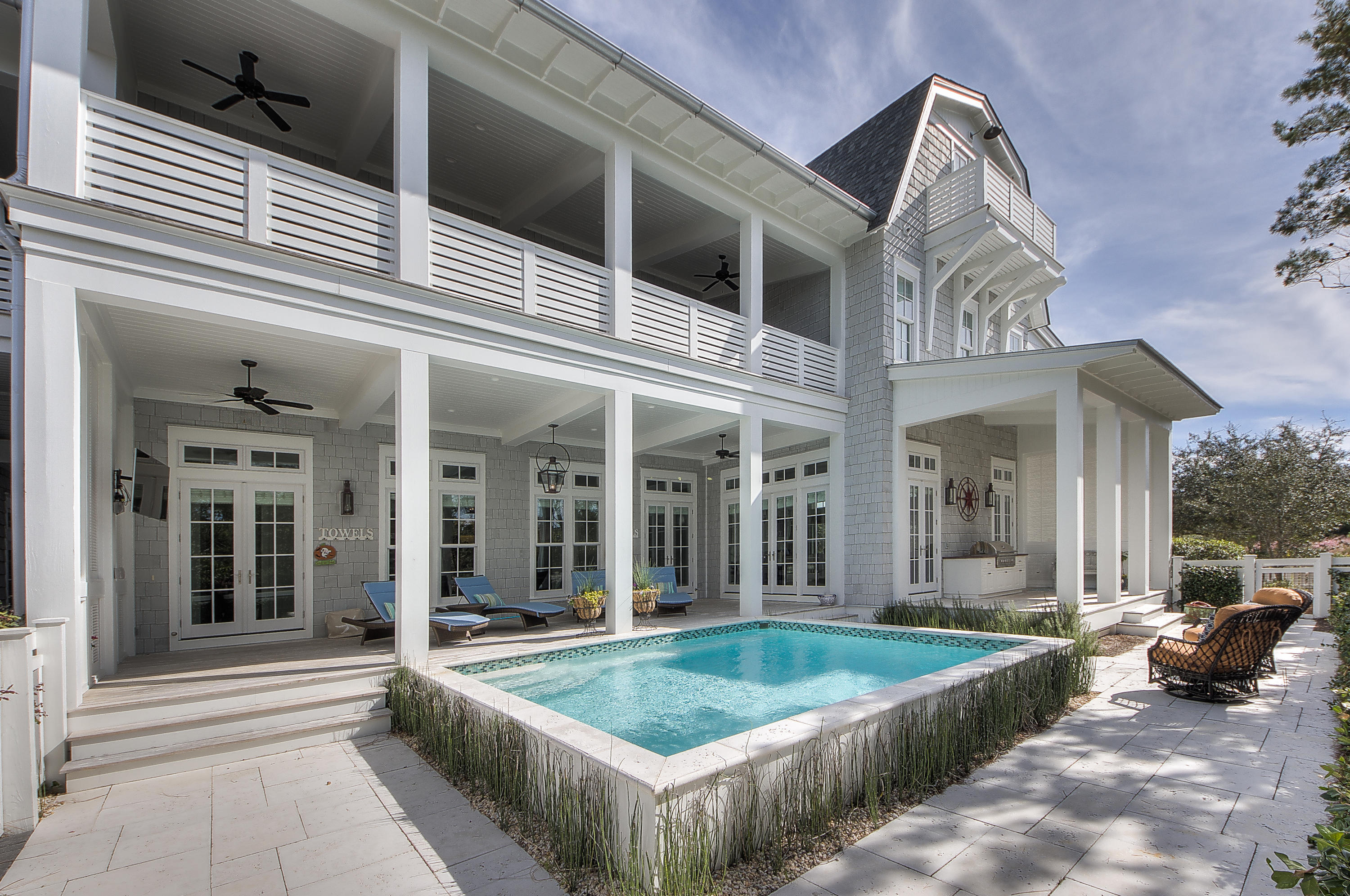 REDUCED! This amazing home was designed by architect Geoff Chick and is located on one of the largest homesites in the community. The private outside retreat is unparalleled in size with an enormous pool, summer kitchen & sun deck with plenty of space for everyone to gather. Throughout the home there are grey washed oak floors, Bevelo lighting fixtures, 12 foot ceilings & other custom details. The first floor offers spacious living & dining areas that allows a multitude of light to come through the windows. The kitchen is a chef's dream featuring Wolf & Subzero appliances, marble countertops, custom cabinetry, double sinks & dishwashers & an enormous island with plenty of space for everyone to gather. There is a junior master bedroom on the first floor with dual closets & coffered ceilings The ensuite bathroom has double vanities, a walk-in shower, & custom mosaic Spanish tile. A powder bath, wet bar & pantry complete the first level. The stunning staircase with custom handrails leads to the amazing second master suite with vaulted ceiling, sitting area, walk-in closet & covered balcony. The spa-like bathroom is adorned in Spanish mosaic tile & marble with dual vanities, zero entry shower & soaking tub. There are also two additional guest bedrooms & ensuites that exude a perfect beach vibe. A second living area & laundry that is concealed by a pecky cypress barn door complete the second floor. The carriage house above the garage doesn't disappoint with a generous living area, kitchen, bedroom & full bath. The third floor includes a bunk room with Gulf of Mexico views, an additional bedroom & full bath. This home, perfectly blending form & function, with stunning architectural features & pride of craftsmanship will leave a lasting impression!