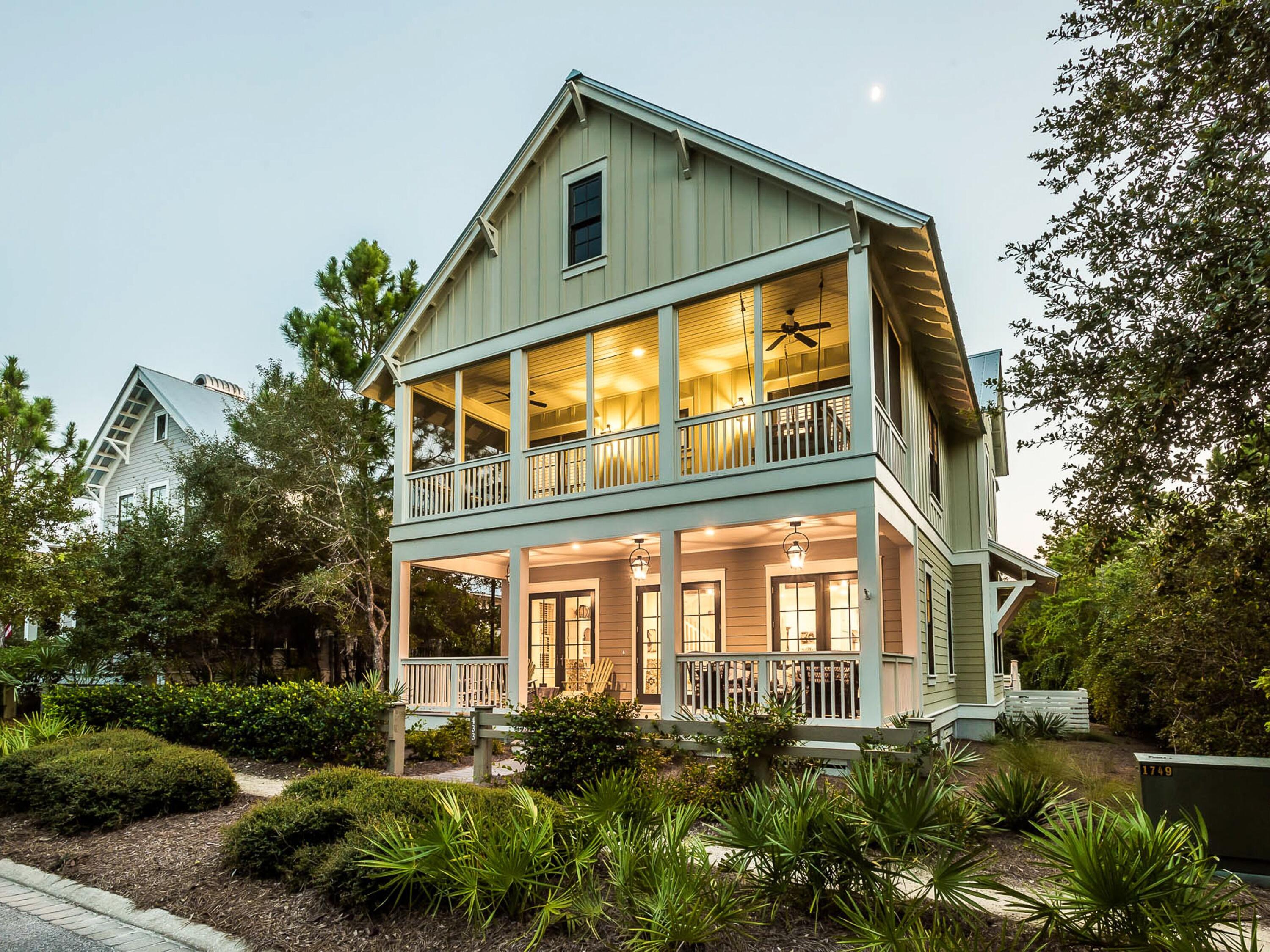 This charming Florida cottage in WaterColor has a large pool area and many noteworthy features. Wire-brushed oak flooring and reclaimed oak beams tie the house to its natural surroundings with wooded preserve on two sides creating unrivaled privacy and tranquility. The open floor plan lends itself to groups and family gatherings with ample space for chatting and socializing beneath the beamed ceiling. The kitchen area with its maple cabinets and granite countertops is packed with extras for chefs and entertainers. There's a six-burner gas stove with a griddle for making stacks of breakfast pancakes while the double oven, two-drawer dishwasher, apron sink and ice maker take care of entertaining. The central butcher's block island is ideal for preparing snacks and meals, served in the dining room or poolside. Outdoor living makes the most of the beautiful location with a deep front porch on the first floor. The screened porch on the upper floor has a coveted bed swing for lazy afternoon naps beneath the gently turning fan. Overlooking the private heated pool, the expansive rear porch is designed for gatherings with deck-style flooring and mesh screens. There's a wall-mounted TV for sports fans and an outdoor gas grill for foodies. Two first-floor bedrooms include a generous master with another guest suite, a four-bed bunk room and a second master suite occupying the second floor. This luxurious master suite has its own screened balcony, Carrara marble floors, a multi-head shower and a claw-foot tub. Four full bathrooms plus a guest bath boast a litany of features including shiplap walls, marble vanities, a standalone tub and stunning glass showers. The home comes with ample parking and currently sleeps 12 guests comfortably. Upgrades to this fully-furnished home include impact-resistant windows and two Rinnai water heaters. Centrally located for enjoying Camp WaterColor, Beach Club pools, tennis facilities, parks, boardwalks and amenities, this home makes a superb second home or high-end investment property for any discerning buyer.