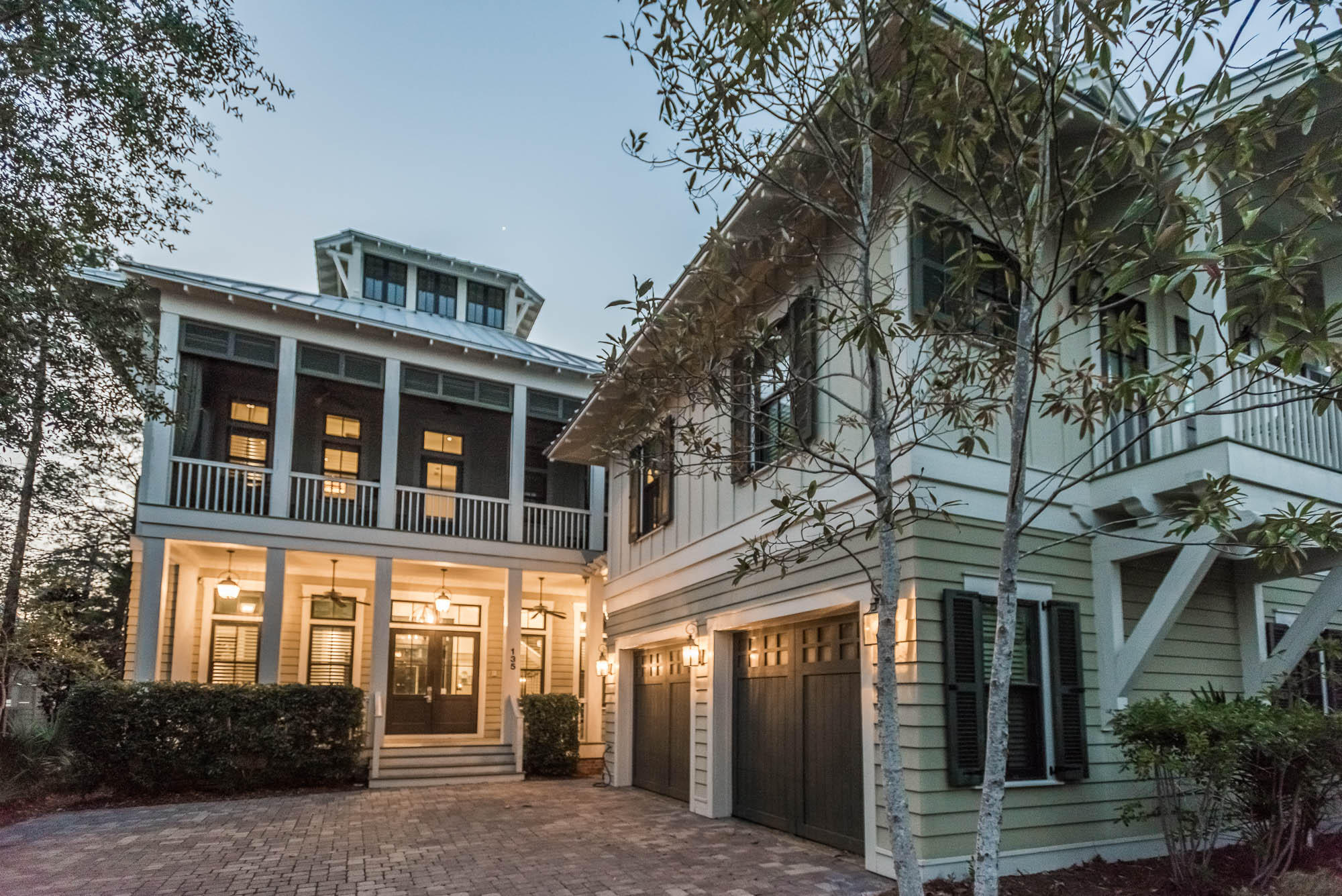 This home is conveniently located on a corner lot overlooking Western Lake and tucked away in the private phase III of WaterColor. Offering a reverse floor plan, this 4 story, 5 bedroom, 5 -1/2 bath home with an appointed carriage house welcomes you with an expansive foyer featuring full wainscoting, wood floors throughout and soaring ceilings. On the first floor, you can find the Master bedroom, as well as, two additional guest bedrooms, each with its own private bath. The spacious master bath features a steam shower, soaking tub, private water closet, his and her vanities, as well as, his and her walk-in closets with built-ins. Double doors from the Master and one of the guest rooms open to a screened in porch. This home features an elevator that services three of the four floors and a conveniently located wet bar can be found on all four floors. The second floor of this home enters to a sprawling kitchen with a large granite island, copper apron sink and two breakfast bars. A Dacor appliance package featuring a gas range and vented hood, a Subzero fridge and freezer with convenient viewing window, and two counter height breakfast bars make this home ideal for entertaining. Off of the kitchen is a screened in porch featuring two floating beds and flat screen TV. The open floor plan transports you to the large living room featuring a beautiful ceiling treatment, built in entertainment center with three additional TVs to survey the driveway, front door and pool via a digital video recorder.  The 10-foot walnut hardwood beam coffered and mitered painted hardwood paneled ceiling spans the length of the living, dining and sitting space of this floor. The living room opens to the open-concept dining room with a solid wood table and seating for 10+. Off of this space is a small private balcony and a large lakefront screened in porch with fireplace, outdoor couch, outdoor kitchen with Teak hardwood base and Dacor gas grill. Also located on the second floor is a private study, full bath, and guest room featuring a private balcony. The third floor offers a large bunk room with built in entertainment center, full bath, and storage space. The fourth floor of this home offers a tower room featuring spectacular sunset views and breathtaking panoramic views of Western Lake. The home's carriage house extends the living space of the main house with a convenient second-floor apartment featuring a living room, kitchen with stainless steel Bosch refrigerator, Bosch dishwasher and Dacor microwave with a guest room and full bath. Below it is a two-car garage that features a built-in SPX American-made heavy duty hydraulic car lift. This home is convenient to the beach and just steps away from the pedestrian bridge that connects to the WaterColor Town Center. Call The Beach Group to schedule a showing of this WaterColor home today!