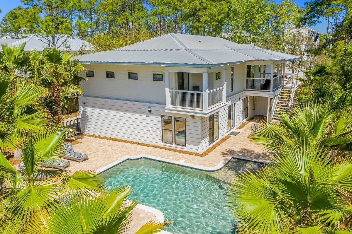 This Canal Street Beach Cottage, aptly named ''Beside Seaside'', is ideally located in Seagrove Beach just steps from Seaside, Public Beach Access and all that 30A has to offer on a coveted private lot! With approximately 3800 square feet, the 6 bedroom (+2 bunk room) home is ideal for a rental investment or a large family retreat. The exterior of the home is manicured with lush tropical landscape which creates a sense of privacy. The second level hosts the spacious kitchen open to the dining area and living room filled with natural light from the vaulted windows. In addition, on this level, you will find the owner's suite with private balcony, 3 guest suites and one of two laundry rooms. Level one provides 2 additional guest suites, 2 bunk rooms, a morning kitchen, the 2nd laundry room and a gracious entertainment room for watching tv or playing games. As an added bonus, the layout of the first floor provides a separate entrance for the 2 bedroom/ morning kitchen area and may be rented as a separate lockout unit. The resort size outdoor sanctuary is surrounded by palm trees with chaise lounges with an outdoor dining and grilling area.  The 12,500 gallon heated pool added in 2016 is one of the largest in the area. This Beach House sleeps 16 and offers a 2 car garage plus expansive parking for all guests.