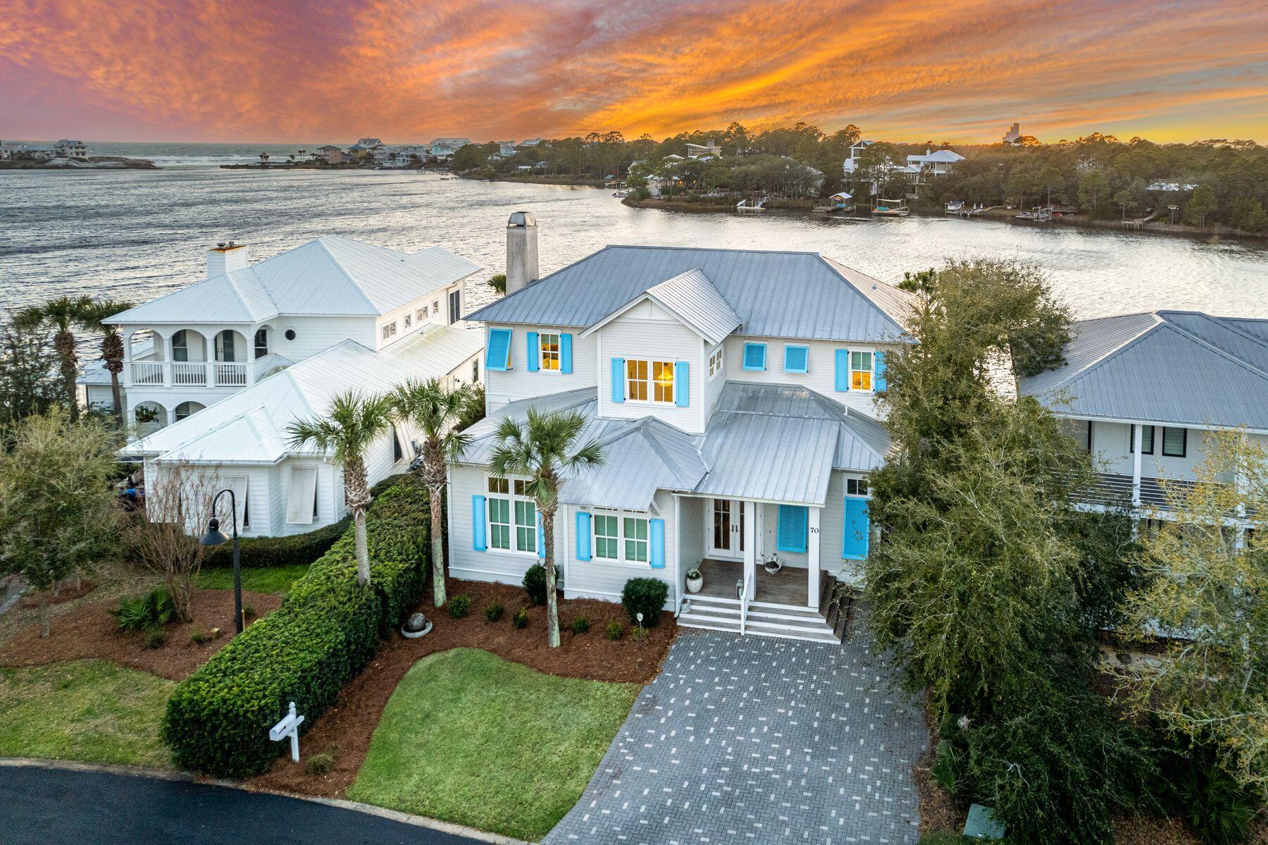Experience unparalleled waterfront luxury and privacy in the rental restricted gated community of Lakewood Pointe Estates. Perfectly positioned on the eastern shore of Eastern Lake, this exquisite two-story residence offers breathtaking, unobstructed views of both the coastal dune lake and the Gulf of Mexico. Indulge in the ultimate waterfront lifestyle with your private dock and automatic 6,000 lb boat lift, allowing effortless access to one of 30A's most iconic dune lakes. Cruise to the beach in style, where sugar-white sands and emerald waters await just beyond the southern shore. Thoughtfully designed and meticulously maintained, this home features an open-concept living and kitchen area that seamlessly blends sophistication with coastal charm. The main level includes a junior primary with an en-suite bath, while the upper level boasts a grand primary suite with a private balconyperfect for soaking in panoramic lake and Gulf views. Upstairs, you'll also find two additional guest bedrooms, a charming bunk room, and a total of three of the four upstairs bedrooms offering breathtaking views of the coastal dune lake. Step outside to a resort-style outdoor oasis, complete with a heated pool, wood-burning fireplace, and a Cumaru deck, all designed to capture the tranquility of the lakefront setting. Interior highlights include soaring 12-foot ceilings, wire-brushed oak floors, and a cozy dining nook overlooking the shimmering waters. Lakewood Pointe Estates is a rental-restricted enclave, ideal for those seeking a full-time residence or a refined second home. Conveniently located just moments from boutique shopping and renowned dining, including 30A's iconic Old Florida Fish House, this property offers an unmatched combination of luxury, privacy, and coastal elegance.