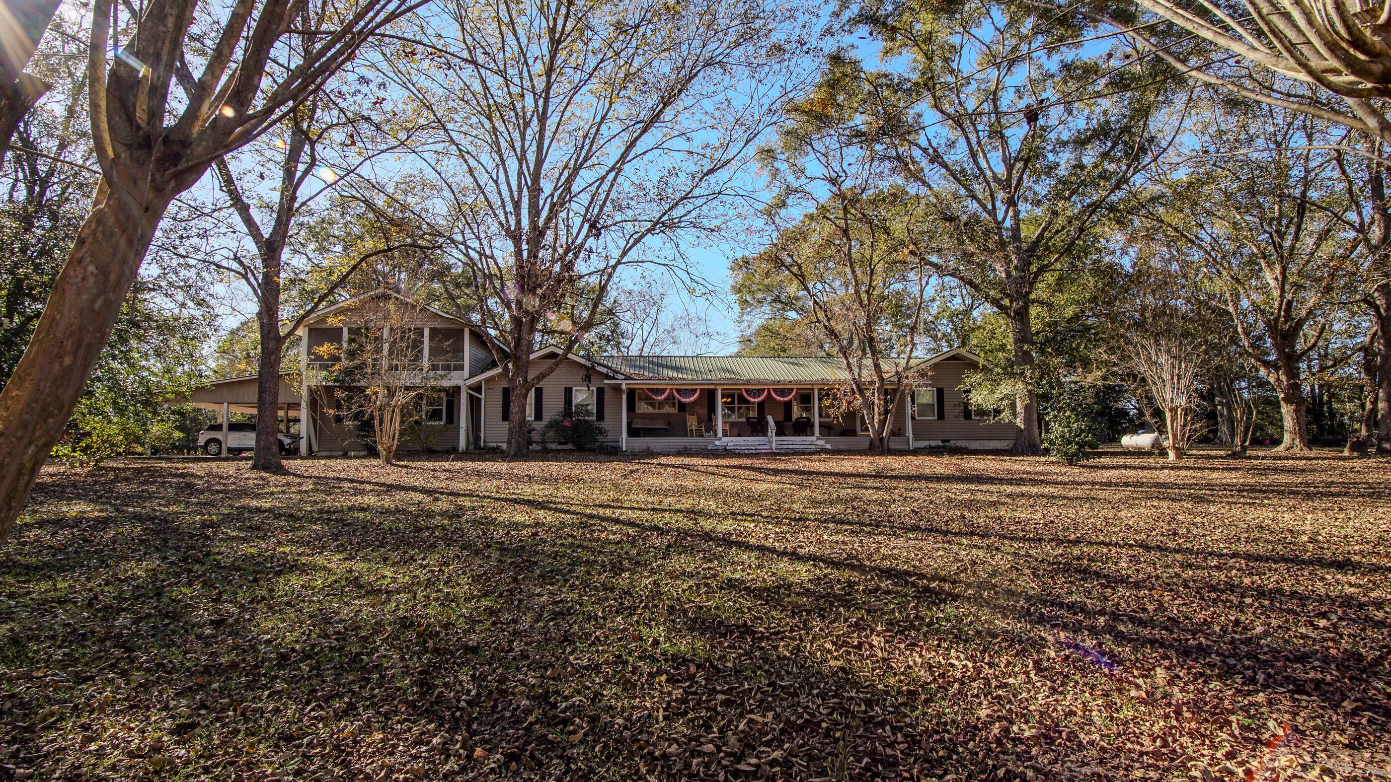 4BR, 2.5BA with home office/game room sits on 22 acres! Property has 2 ponds, ideal for fishing or just peaceful enjoyment. Multiple utility buildings provide endless storage and workshop possibilities, including a substantial72x32 barn and various outbuildings ranging from 12x8 to 24x12. The saltwater pool features a generous 50x30 screened enclosure. Inside, beautiful bamboo flooring through the living and dining areas with a large gas fireplace anchoring the main living space. The mature landscape includes productive pecan trees, fig trees, and grape vines that practically turn your yard into a mini orchard. A whole-house Generac generator ensures you'll never be without power. This is best of country living located just over the Florida line for easy access. Home sold as is!