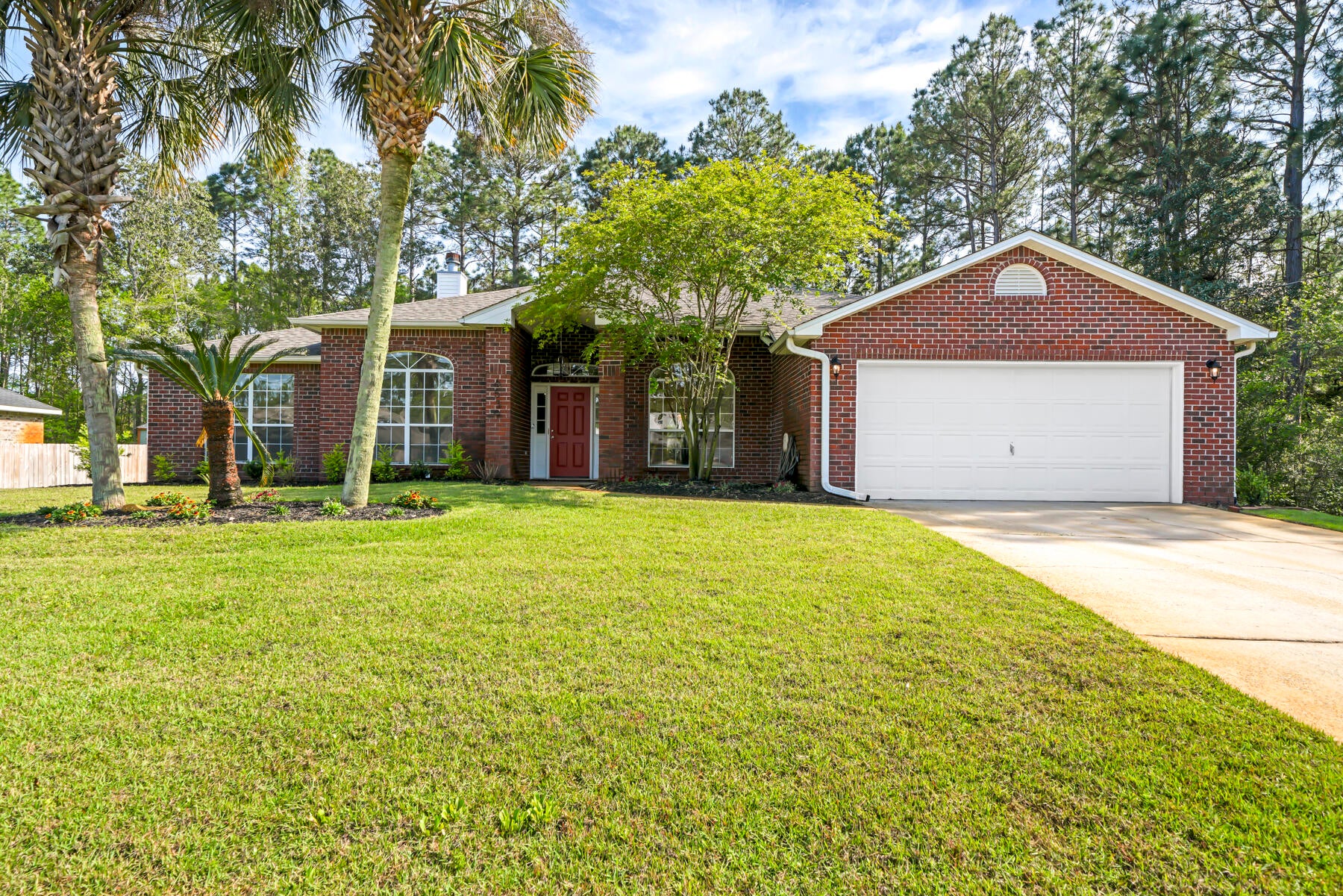 Welcome to this charming all-brick home boasting 4 bedrooms and 3 full baths! Step inside to discover the timeless beauty of porcelain wood plank tiles that stretch throughout. Fresh paint and modern lighting fixtures add to the welcoming atmosphere, while ceiling fans offer comfort with convenient remote controls.

The heart of the home, the kitchen, awaits your culinary adventures. Custom cabinets in pristine white are complemented by dove grey islands, creating a serene ambiance. Stainless steel appliances promise delicious meals, including a stainless refrigerator, and a handy pull-out pantry adds convenience.

Retreat to the peaceful master suite, complete with a luxurious master bath featuring a separate shower, double vanity, and indulgent garden tub. Slide open the doors to the screened porch and let the gentle breeze soothe your senses.

In the evenings, gather around the cozy all-brick wood-burning fireplace in the spacious great room. And when it's time to explore beyond your doorstep, discover the vibrant community of Holley by the Sea. Here, you'll find multiple pools, a full gym, tennis courts, a walking track, and access to the water, offering endless opportunities for leisure and recreation.

Welcome to your new home at 6539 Redfield St Navarre, FL, where every detail has been thoughtfully crafted to provide comfort and tranquility. (Please note: Certain items are excluded from purchase, inquire for details.)