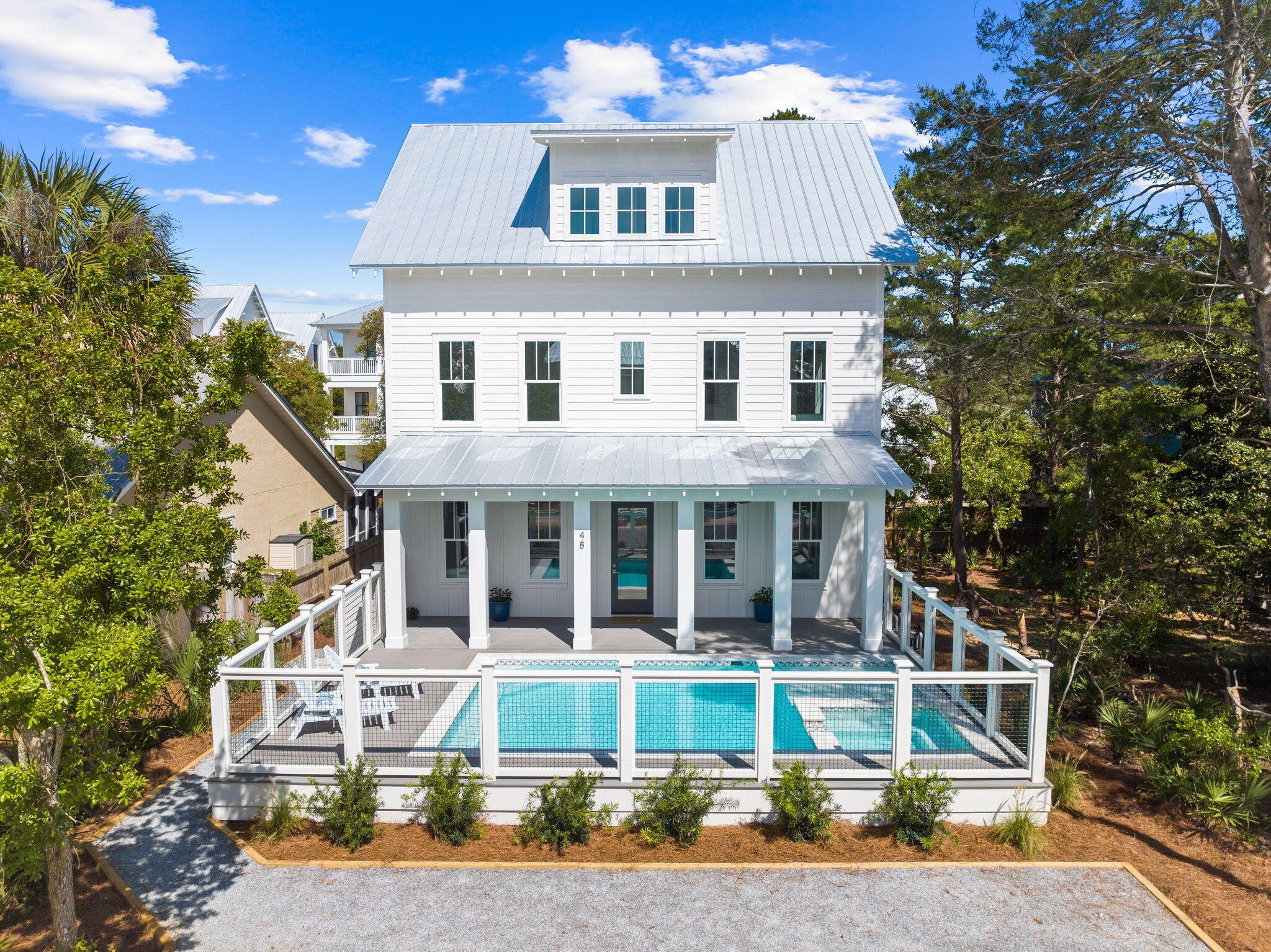 Experience unparalleled luxury at our newly constructed beach home, perfectly nestled just steps from Seagrove Beach and within walking distance to local shops and eateries. This stunning retreat features 5 bedrooms, including a bunk room with 4 queen beds, and 5.5 bathrooms, each with bespoke tile work, spacious closets, and private ensuites for ultimate privacy and convenience. The open concept living area boasts heated pool views, complemented by shiplap walls and premium finishes throughout. The gourmet kitchen is a chef's dream, outfitted with custom cabinetry, luxury appliances, and a spacious pantry. Ideal for large gatherings, this home spans over 3200 square feet of living space, including a master suite with a large bath and double vanities, a cozy reading nook, and a beverage bar. Outdoor living is equally impressive, with a front yard pool, hot tub, and a tanning ledge, making it a prime spot for entertaining or relaxing. Situated south of 30a, this beautiful coastal retreat offers the perfect blend of privacy and convenience, making it an exceptional choice for those seeking a luxurious beachside living experience.
