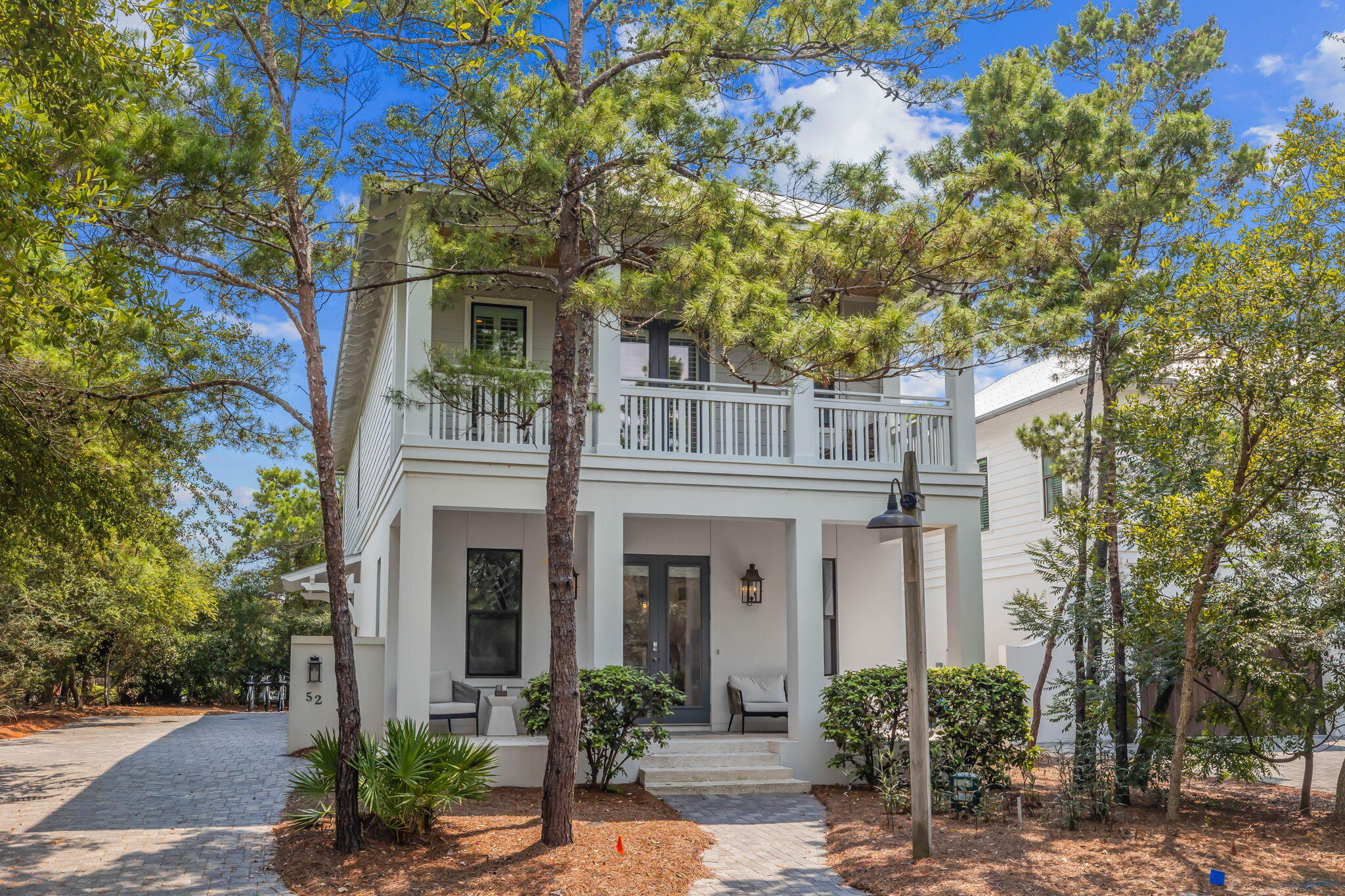 The gated neighborhood of Pinecrest, located South of 30A and next door to Rosemary Beach is just steps to all that 30A has to offer from celebrated restaurants, shops and the sugar white sands that lead to the emerald waters of the Gulf of Mexico.  With only 12 homes, this quaint community provides a secluded get away to enjoy the private pool and easy access to the beach from a neighborhood easement. The deep front porch with multiple seating areas welcomes you to 52 Pinecrest Circle. Offering a beautifully furnished 2,700 sq ft home with 4 Bedrooms, 3 Full Baths and a Half Bath. Conveniently located on the first floor, the King primary suite with classic marble spa inspired bathroom with jetted tub, double vanity and walk-in shower along with an entertainers Kitchen, Dining Area for six, and a spacious living area complete the first floor. On the second floor, enjoy another living space with a 55" TV, mini fridge and wet bar another King primary suite with clawfoot tub, separate shower and double vanity all behind a custom barn door. The third King suite with oversized shower and the fourth and final Queen guest room finishes the second floor. Enjoy grilling and hanging out on the back deck with a dining and lounge area or swinging on the upstairs porch swing. Plenty of places for everyone to enjoy their time away.