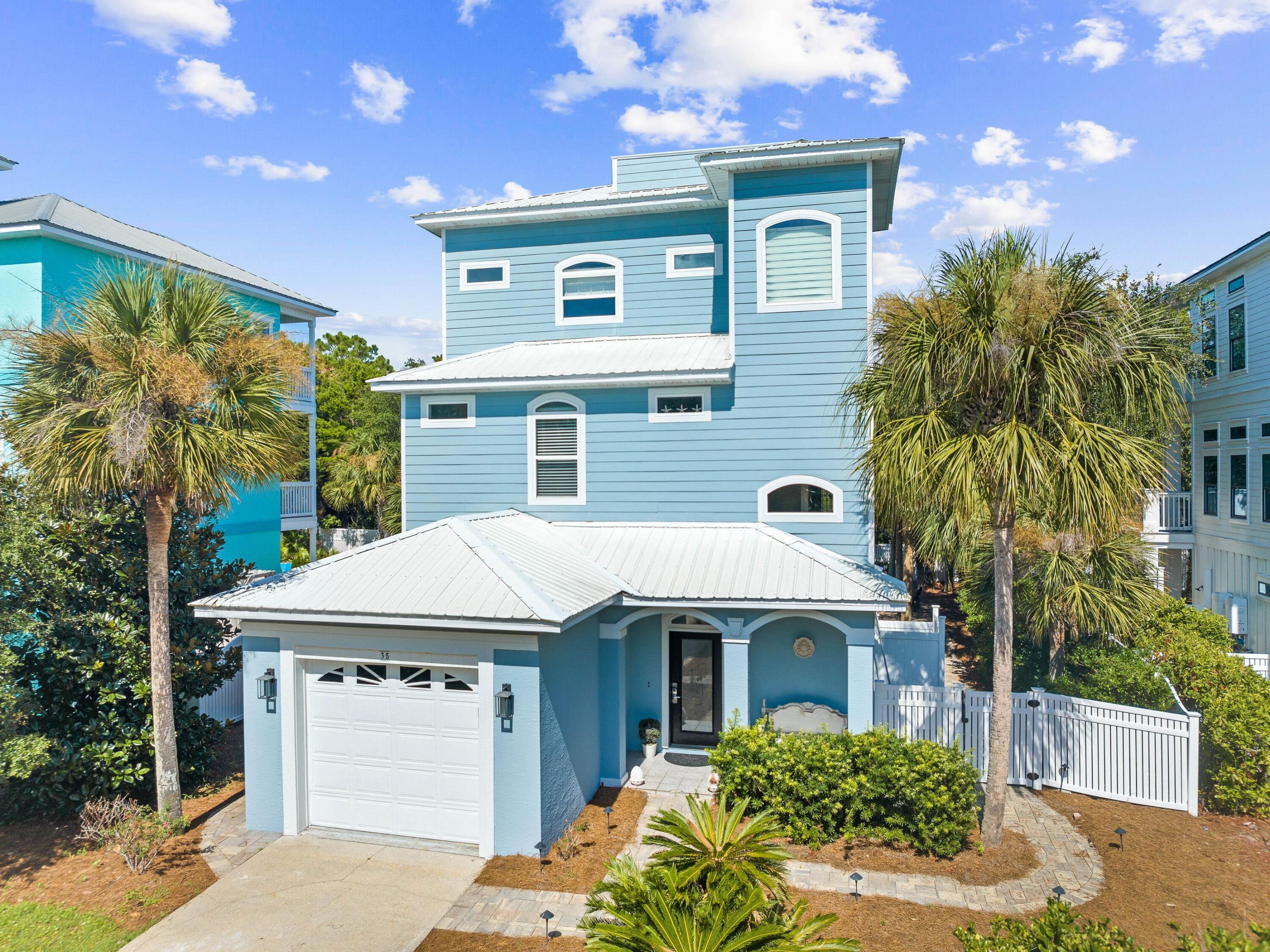 Just south 30A, this completely remodeled home is a short walk from shops, restaurants and quiet beach access. Backing up to green space, this well-located property has a superb back yard with a private pool and expansive gulf views from the rooftop patio. Recent updates to this spacious retreat include adding a fifth bedroom and a full bathroom. Plush furnishings and LVP flooring complement the calming beige décor in the second-floor open-concept living room. It includes a formal dining area and a large wraparound balcony furnished for outdoor living. A granite-topped breakfast bar with stools heralds the open kitchen area. Ample white cabinets and stainless steel appliances provide everything you need for family mealtimes and entertaining. Three first-floor bedrooms are spacious and inviting. They include a king bedroom, a queen bedroom and a four-bed bunk room. Two bedrooms have direct access to the pool for a peaceful morning swim before breakfast. There's an additional guest bedroom on the second floor. The third floor is reserved for the generously sized master suite, boasting a king bed and a balcony overlooking the oval pool. The master ensuite has a twin vanity, deep soaker tub and a large walk-in shower. Head up the stairs to the fourth-floor observation deck for panoramic views of the shimmering Gulf of Mexico and surrounding coastal communities. It's the perfect spot for enjoying sunset drinks and quiet moments after a busy day. The fenced backyard is a peaceful haven with a beautiful heated pool, a covered terrace for alfresco living and an outdoor shower. Backing to green space, it is very private and easy to maintain. The home is fully furnished and turn-key, making it attractive as a second home or vacation rental to sleep 12 guests. As well as a garage, paved parking at the front of the property can accommodate multiple vehicles. The location of this magnificent beach home is hard to beat. The Caribbean Sunrise community is well-positioned for Gulf Place shopping, dining and 30A attractions. Just a short walk away, the Spooky Lane public beach access is particularly quiet as it has no parking. Ride bicycles or walk to Shunk Gulley, Pizza By The Sea, Local Catch or The Perfect Pig for dinner or explore the neighboring communities of Blue Mountain Beach, Grayton Beach and Seaside, Florida.
