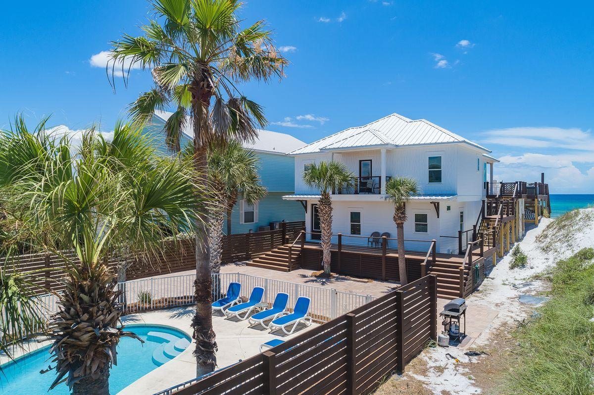 Situated on more than a half-acre in Miramar Beach, and right on the Gulf of Mexico, this inspiring beach bungalow has been fully renovated and provides picturesque views of the emerald green waters only footsteps away. The 3,616-sq.-ft. home is projected to eclipse $409k in gross rental income, sold fully furnished, and can accommodate 24 people with five bedrooms in the main house and an additional two bedrooms in the carriage house. Completely remodeled from the ground up, the exterior of the home offers all new HardiePlank, new roof and impact glass windows, a spacious and updated outdoor deck with expansive beach views for outdoor dining or entertaining, a new privacy fence, and a private path to the gulf waters. Interior provisions include an open living area with expansive... windows and a high ceiling, while the gourmet kitchen features quartz countertops, brand new stainless steel appliances, and a wine cooler. This home has been freshly painted inside and out and has several high-end finishes, including elegant furnishings and decor, modern coastal light fixtures, new flooring throughout, bathroom upgrades, and beautiful custom-tiled bathrooms. Additional updates include new A/C units, tankless hot water heaters and gas pool heater. Offering 50 feet of gulf frontage and plenty of parking, this exquisite home offers high rental earning potential, or an idyllic locale for a secondary home. Take a dip in a private pool or enjoy easy access to one of the infamous Emerald Coast beaches - just steps from the house. Located off Highway 98, this home is also just a quick drive to some of the area's best shopping and dining destinations.