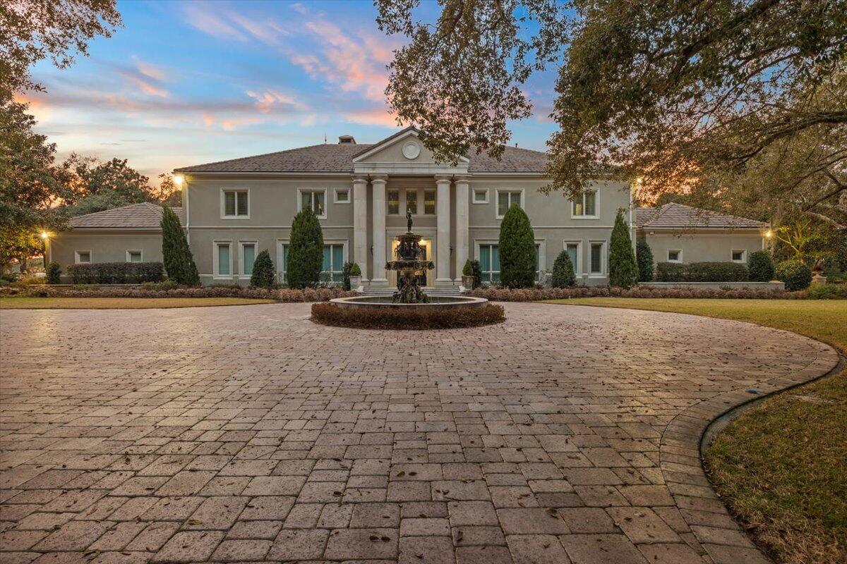 This exclusive Waterfront Estate is located on a private 4.5 acre lot, featuring lush landscaping and large oak trees with over 281 feet of deep water frontage on Joe's Bayou. Hidden in the heart of Destin. Features of the spacious 9188 sq. ft home includes, an elegant master suite wing with bedroom and large sitting area, fireplace, a large dressing closet room, exercise room with full length mirrors, an Italian marble tile master bath, a coffee bar area, and magnificent views of Joe's Bayou. The grand room has a soaring ceiling with stone floors and French doors that open to area with heated pool and spa that overlook the bayou. A gourmet kitchen includes a breakfast area, pantry, butlers pantry, top of the line appliances, cook-top island, double ovens with warming drawer, wine cooler and is accented with stone floors and granite counters. On the second floor there is an entertainment living room with a full size bar, ice maker, bar refrigerator, and media area and 5  bedrooms.  Additional features include a sandy beach, fire pit area and a deep-water dock with two large deep water boat slips. One of the deep water slips has a 40lb. lift that can accommodate a 55' boat. Every plant and tree was hand selected for this especially manicured estate. A handicap-ready bedroom and bath on the first floor, central surround sound system, Smart Home, large heated pool and much more!