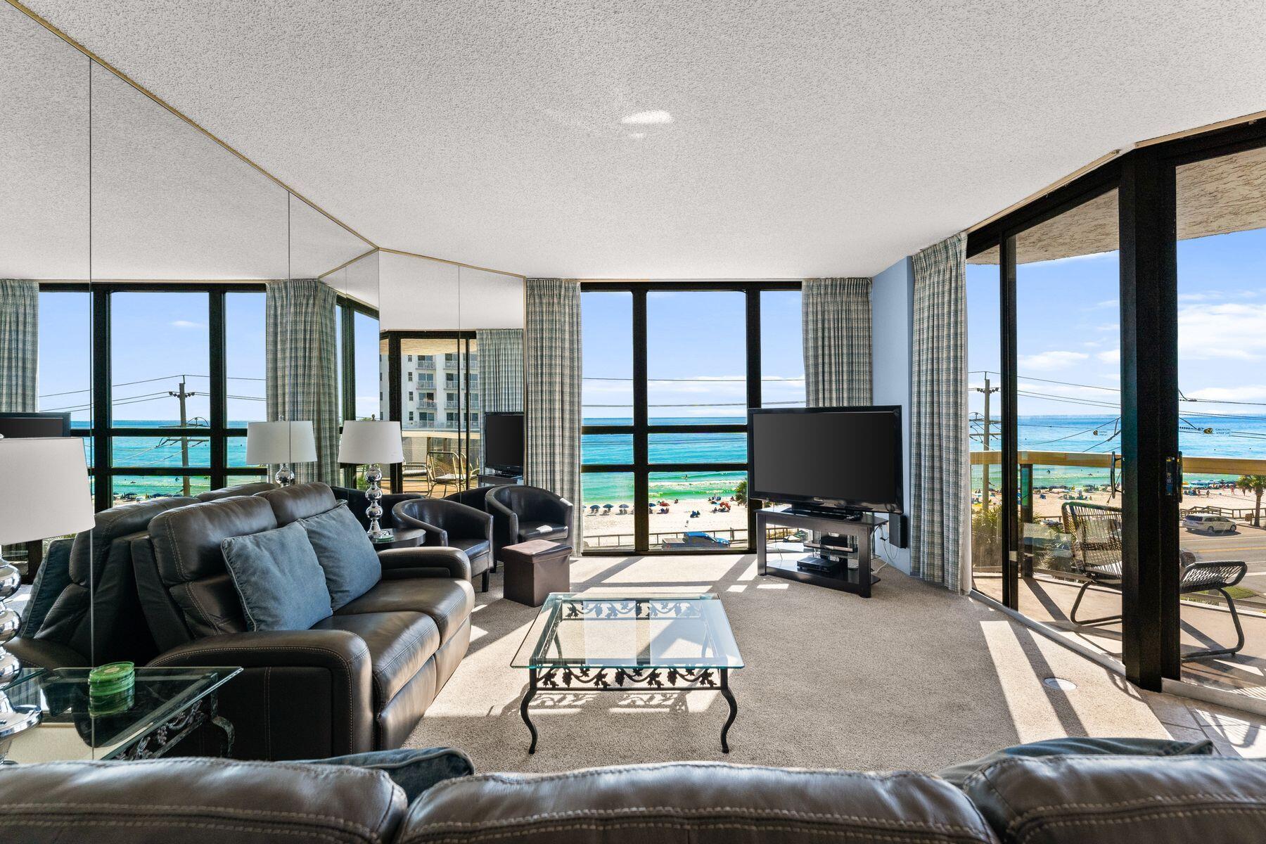 Panoramic gulf views define this versatile three-bedroom residence in Surfside Resort, where every bedroom and the main living area open to a balcony overlooking the sugar-white sand and emerald waters below. Designed for both enjoyment and investment, the unit offers a flexible lockout configuration—rent it as a full three-bedroom, three-bath condominium or as separate two- and one-bedroom suites to maximize income potential. The interior features a bright coastal palette with tiled counters, updated appliances, and generous gathering spaces that frame the water beyond. Each bedroom offers its own balcony access, ideal for morning coffee or sunset views that stretch across the horizon. Surfside Resort is celebrated for its full suite of resort amenities, including a beachfront pool and hot tub, private beach access, fitness center, tennis and shuffleboard courts, and on-site dining at Royal Palm Grille. Guests and owners also enjoy the convenience of covered parking, interior corridors, and the indulgence of an in-house spa and salon. A proven rental performer and a turnkey retreat, this condominium captures the essence of effortless gulf-front living.