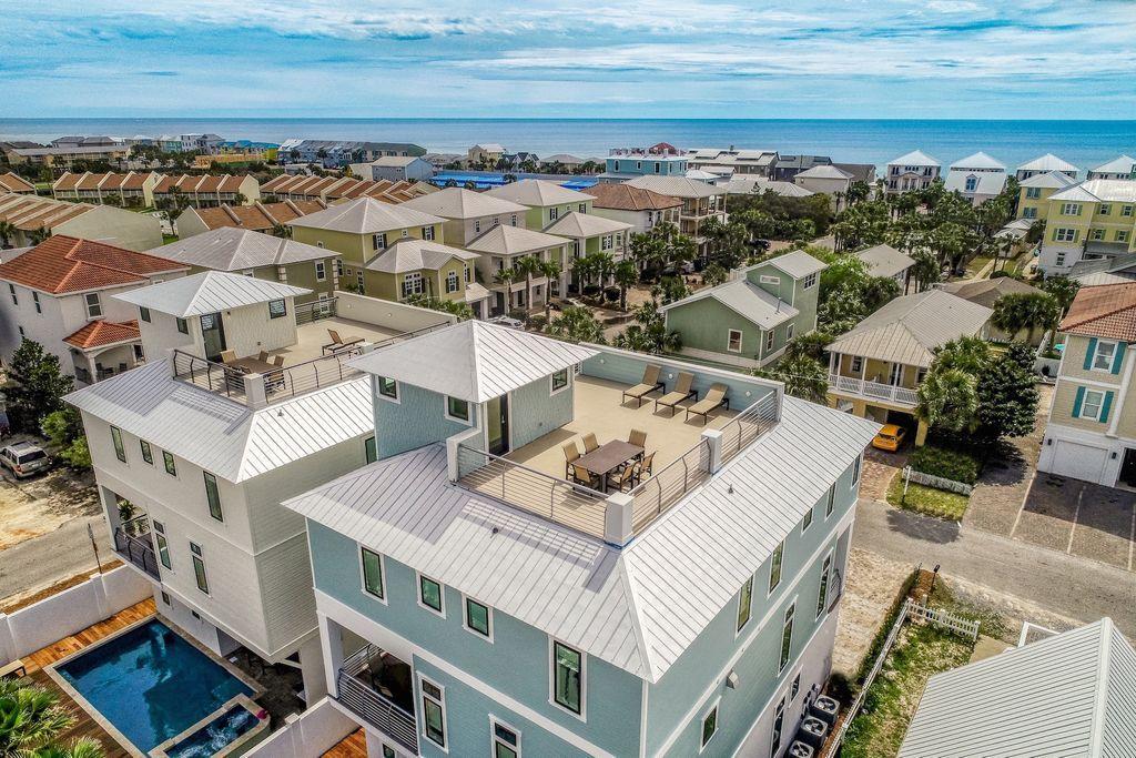 Sleek coastal contemporary design perfectly situated to capture gulf views & masterfully configured providing unparalleled amenities including a Watermark-built private resort style pool area complete with a covered outdoor summer kitchen. This is the ultimate beach house, recently completed in early March 2019 offering excellent income opportunity with +$250,000 in gross projected annual rental income and over $100,000 already on the books for 2019. This home was designed to maximize functionality and finely appointed with chic contemporary finishes while affording optimal comfort & living space. Notable features include multiple indoor and outdoor living areas, private commercial grade elevator, dual master suites with gulf views, built-in pinterest worthy bunkbeds, indoor and outdoor surround sound system as well as security cameras for optimal privacy. The first floor layout boasts a spacious bunk room, full size laundry area, large bedroom with ensuite bath as well as an industrial style game room complete with a pool table & built in wet bar including a full size paneled fridge and refrigerator drawers flowing seamlessly out to the rear pool deck and covered outdoor living area. The second floor is the focal point of indoor living space with a sleek contemporary living room featuring floor to ceiling windows to soak in natural light & gulf views, built-in entertainment center with floating shelves and open to the kitchen & dining room for optimal flow. The ample sized kitchen features floor-to-ceiling custom contemporary cabinetry, Sub-Zero appliances and Wolf professional series gas range, ample storage and is anchored by a massive center island crowned with gorgeous quartz countertops. The second floor also features two full bedrooms with ensuite bathrooms, convenient half bath as well as access to the second story outdoor dining area overlooking the lagoon style pool. The third floor features three full bedrooms including dual master suites with spacious porches, laundry area, bunk room as well as a fourth story viewing deck to maximize the incredible gulf and western oriented views that surround this prestigious home. Frangista Beach owners enjoy multiple deeded beach access points steps from the home and centrally located near world class golfing, dining, shopping & entertainment.