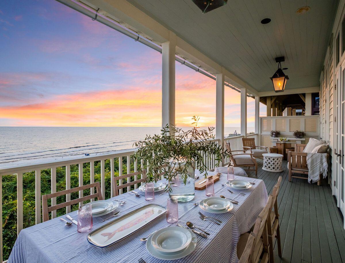 Pristine architectural styling and exceptional highly curated interiors by Ashley Gilbreath Interior Design characterize this prominent Gulf front home primely positioned in a prime corridor of Rosemary Beach. Presiding over 66' of linear beach frontage, this compound property is a rare estate sized home ideally situated to enjoy the surrounding new urbanism lifestyle along the east end of 30A while yielding exemplary privacy from the walled courtyard facade of this remarkable retreat. Proudly yielding over 3,600 sqft of heated living space including a separate carriage suite, this fully remodeled five bedroom, five and a half bath masterpiece is thoughtfully configured as a multi-generational estate with optimal living arrangements. The courtyard entry and private resort-style pool offer an incomparable sense of arrival accentuated by lush manicured grounds including mature citrus & jasmine. The main house features an inverted living plan to maximize gulf views while providing ample space for entertaining. The first level is anchored by a cozy living space and naturally lit entryway with two generously sized gulf front bedroom suites flanking each side. There is an additional bedroom suite and spacious laundry room as well as direct access to the full floor covered porch overlooking the beautiful Gulf of Mexico. The first level porch allows for direct beach access and landscaped privacy with ample space for entertaining and relaxation.
The ascension up the stairwell includes impressive visual art and direct access into the expansive main living space defined by an open floor plan with sophisticated vaulted ceilings, grandiose fireplace, antique parisian artwork and floor to ceiling glass windows to soak in unimpeded Gulf views. The chef's kitchen is anchored by a sprawling center island with a refined walnut countertop and custom cabinetry adjacent to the professional series gas range, refrigeration and apron sink overlooking eastern vistas of the Gulf of Mexico. The second floor hosts the owner's retreat, which features a Juliette balcony overlooking the courtyard, timeless Chadder & Co. bathtub in the spa-like ensuite bath & shower surrounded by timeless marble accents, antique double vanity and a generously sized walk-in closet. A second-floor covered balcony features a grilling station and ample space for al fresco dining or unwinding. Inside the one-bed, one-bath carriage house, notable architectural features abound including double height ceilings with exemplary windows overlooking the pool & courtyard as well as hardwood flooring, a kitchenette with full-sized appliances including a Bertazzoni range, vent hood, farmhouse sink and a workspace that offers gulf views. The exterior space is significant and well planned yielding two private courtyards with double outdoor showers, garage entrance, patio seating and a heated saltwater pool with a water feature as well as gated beach access. Fully renovated in 2020, this renowned masterpiece embodies traditional southern charm with coastal elegant finishes and is being sold mostly furnished with owner exclusions and has dedicated space for adding a private elevator. Rosemary Beach is a jewel on northwest Florida's Scenic Highway 30A, a blend of old-world charm and world class shopping, dining, farmer's markets and family atmosphere.