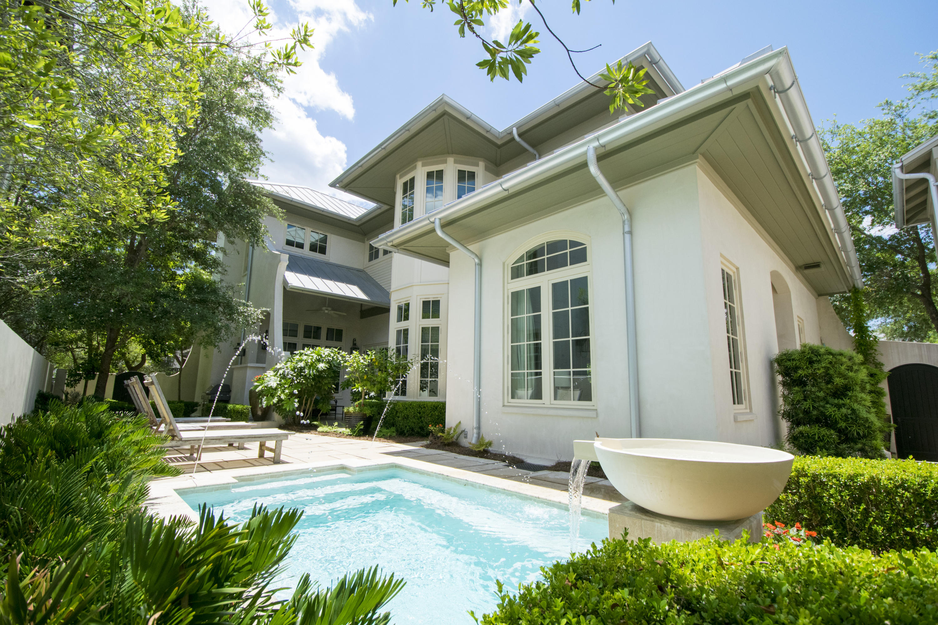 This property is an exquisite luxury home in a very casual coastal setting. This gorgeous home boasts the living, dining and kitchen on the main along with a guest bedroom, full bath and office. The kitchen has a Wolf gas cooktop and range, SubZero refrigerator and separate wine refrigerator. The walk-in pantry provides an abundance of space including an ice machine. Follow the flow of the custom staircase up to a luxurious owners suite with a large relaxing sitting area and beautiful bath. This second level also provides a guest suite and 2-bunk bedroom and bath plus a laundry room.
The spacious courtyard includes a private heated pool with water fall feature and salt filtration system.
The Carriage House features a bedroom and bath plus a 4-Bunk and bath loft area. Inclusive of a full kitchen, dining and living area for your extended family and guests.  Will provide short list of exclusions, some artwork and personal items.  Buyer to verify all measurements.