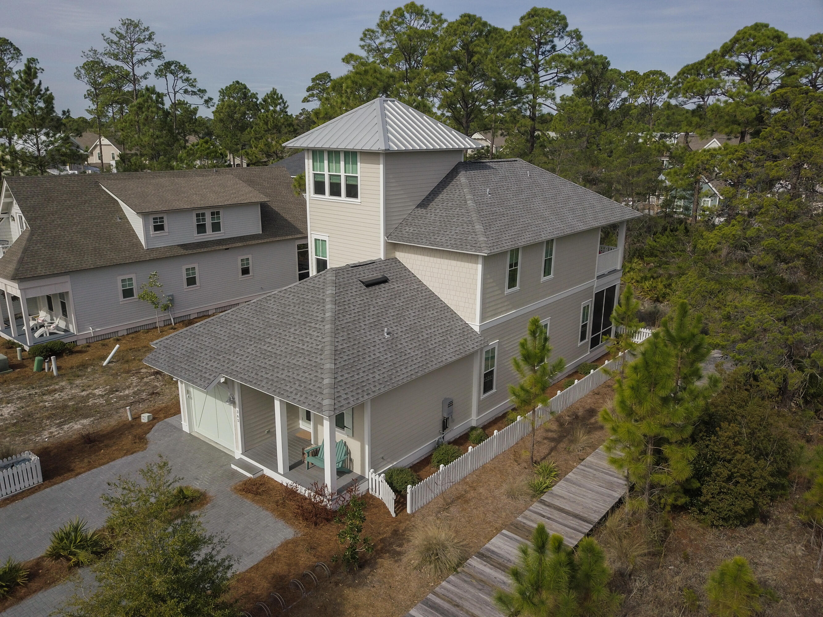 Beautiful custom beach home just steps from the beach boardwalk and pool in Watersound West Beach.  Perfect for a family retreat or vacation rental, this lovely home boasts two master suites (one on each level), upscale kitchen that is open to the living & dining areas, two guest rooms, three porches, bonus space, single car garage, and more!  Special features include Wolf Range & Sub Zero fridge, shiplap in all first floor living areas, designer furnishings & decor, quartz counters, and third floor bonus room with beautiful views!  The second level master suite is a perfect getaway at the end of the day and features a beautiful sitting room, ensuite bath, walk-in closet, and private porch with hanging bed.  There is also an outdoor shower and fenced area for pets. Offered fully furnished. Watersound West Beach features a community pool/clubhouse, putting green, boardwalks and trails, green spaces and parks, boardwalk to the beach, security gate, high speed fiber optic internet, and fitness center at Watersound Beach. The beach access through Deer Lake State Park is a perpetual easement so no customary use worries here! And no crowds! Live the beach life!!