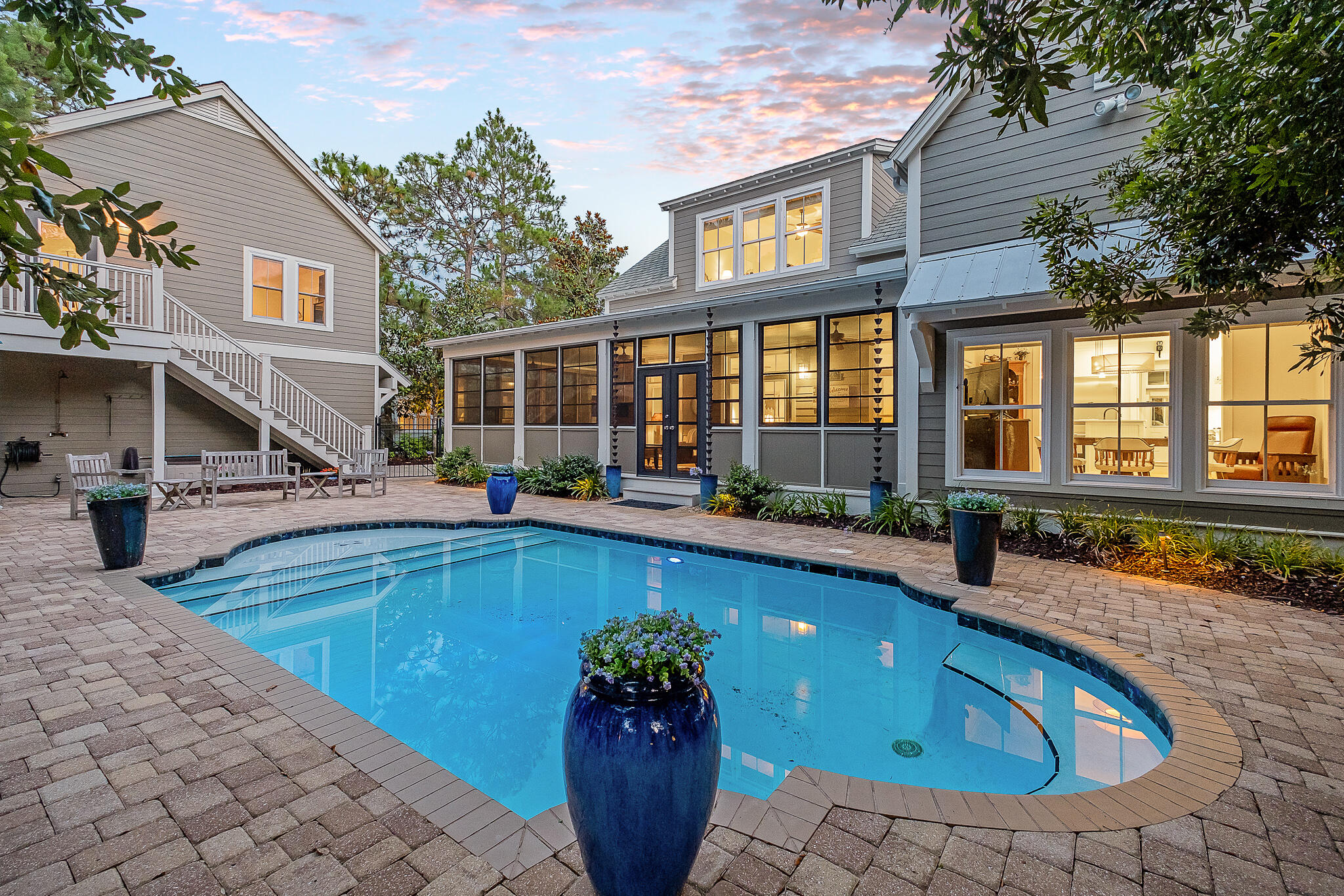 Stunning Southern Living inspired design on a spacious lot with private pool in the highly coveted community of Sugarwood in Seagrove. This single owner home has never been rented and has been meticulously maintained by it's full time residents. Mature landscaping and trees welcome you as you pull in to the driveway. A separate detached garage with finished room above would make for an easy carriage house conversion, while currently serving as a home gym.  The main house contains a thoughtful concept that blends indoor and outdoor living with it's large wrap-around screened porch extending out to the heated pool and paver deck. Enjoy an open concept living/kitchen with a plethora of built-ins. The adequately stocked kitchen features a Thermador 6 burner gas cooktop, Bosch dishwasher, elevated appliances, stovetop water filler and more. The adjacent pantry/mud room is a featured highlight sure to please the most discerning buyer. The main level has beautiful wood floors and contains the master suite plus an additional bedroom, currently being utilized as an office. The powder room on the main level is oversized with room to add an additional shower if desired. New countertops compliment both the kitchen and the baths. The upstairs has 3 bedrooms with additional expansion room. You will feel the level of maintenance this beautiful home has experienced the moment you walk through the door. Sugarwood offers a secluded feeling with it's spacious lots while being located in the heart of Seagrove Beach. It's just a short stroll to several public beach access points, shopping, dining, and all that 30A has to offer.
