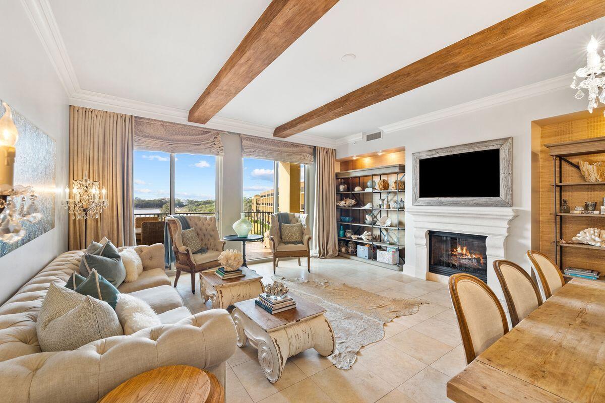 Boasting tasteful decor by Lovelace Interiors, this stunning top-floor condo is a true Sanctuary by the Sea. It comes with its own private poolside cabana, which is far from the ordinary. This air-conditioned space has a living room with bar and a full bathroom for the ultimate lifestyle experience. The entire condo was meticulously renovated with no expense spared. The result is a breathtaking home that displays careful attention to every detail. Ten-foot beamed ceilings, glittering chandeliers, a feature fireplace and custom furnishings allow you to relax and enjoy the views from a place of comfort and luxury. Step inside this haven of luxury and admire the lake and gulf views from the living room, dining area, kitchen and master bedroom as well as from the balcony. Carefully curated furnishings and neutral decor echo the coastal location along with beach-inspired accents. The chef's kitchen is an epicurean masterpiece with bespoke birch-wood cabinetry, Viking appliances and a double range. Hand-laid crushed seashells adorn the ceiling and backsplash. Serve sunset cocktails and perfectly chilled wine to guests at the wet bar when entertaining. Four gorgeous ensuite bedrooms include a Versailles-worthy master with fabulous mirrored closets and direct balcony access. Imagine taking long bubbly soaks in the deep copper tub with gulf views, or enjoying a temperature-controlled steam shower beneath the pearlized ceiling. Sea glass tiles enhance the backsplash on the double vanity. This beyond-ordinary condo is one of 82 luxury homes located on 23 acres of prime property. As well as 65 feet of gulf frontage, it overlooks Redfish Lake, a rare coastal dune lake. Three beautiful pools offer the ultimate outdoor experience with private cabanas, waterfalls, fountains and hot tubs. Socialize with your peers at the gulf-front owners' lounge or around the BBQs and fire pit. Other outstanding amenities include a state-of-the-art fitness center, theater room, virtual golf simulator, high-tech video arcade and owners' storage. This landscaped paradise is within easy reach of top-rated golf courses, shopping, dining and endless outdoor recreation at Point Washington State Forest and Grayton Beach State Park nearby.