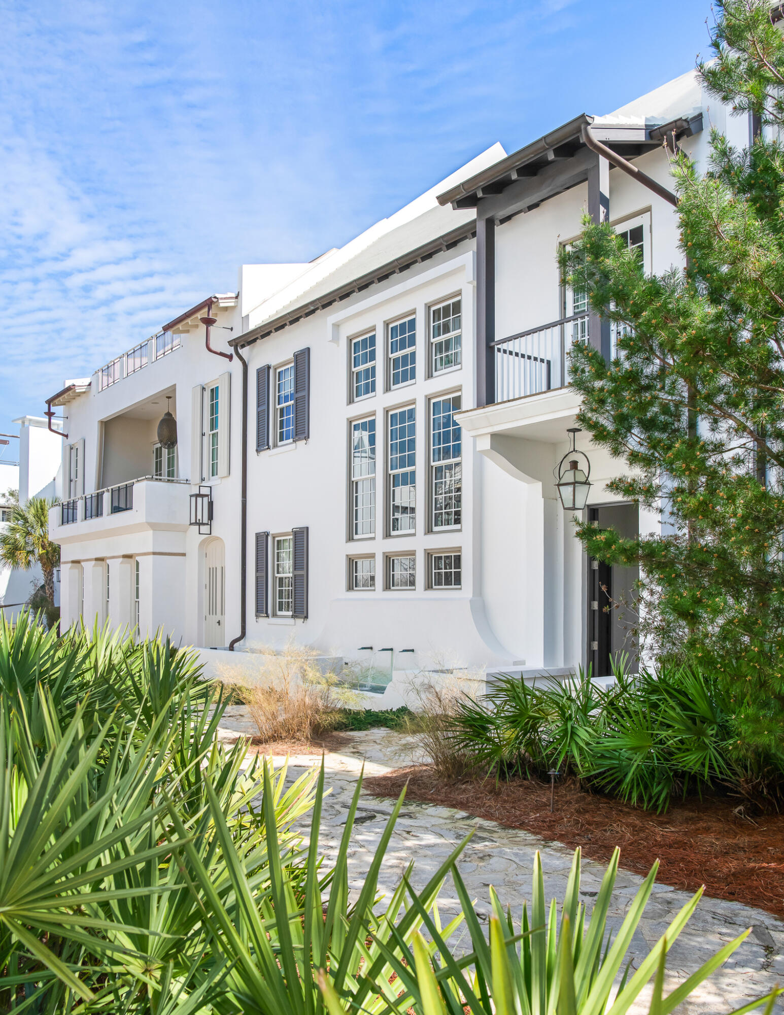 TMc Architecture created the quintessential Antiguan influenced home that Alys Beach personifies, pairing the indoor living with the outdoor.  Connectivity begins with the 1st level kitchen, dining, & living rooms that open to the private courtyard hosting an enclosed loggia featuring beverage center, grill, & fireplace.  Operable glass doors function to enclose for those chilly evenings.
The primary elevation fronts the award-winning Sea Garden Walk pedestrian path creating a special environment for guests to enter the home and easy pedestrian travel to the private owners Beach Club, Caliza Pool, and Zuma Wellness Center.  North to Lake Marilyn & the nature preserve or south to the beach by way of Sea Garden Walk.  
Entering the home draws attention to the ebonized machined steel, floating staircase softened by reclaimed Oak stair treads derived from the same origin as the Oak ceiling beams and flooring.  11' ceiling height paired with full height windows nicely transfers the east to west sunlight throughout the dining, kitchen, & living areas reflecting upon the Venetian Plaster for peaceful ambiance.
The kitchen is appointed with professional appliances centered with a large marble island looking upon the dining & living area.  For work interruptions, an office located privately off the kitchen is available for such.  Outdoor entertaining is achievable having the outdoor covered loggia adjacent from the kitchen leading to the courtyard open to the sky.  Guests will be enamored by the uses of the private outdoor gathering spaces.
55 Hog Penny Alley boasts 4 bedrooms plus a double bunk room to accommodate family & friends. The primary bedroom suite is exclusive capturing privacy that opens to a personal roof terrace for those moon lit nights. In addition to, the primary has a private stair hall with direction to the home's glass, enclosed studio providing refuge as a media room, secondary living room or for a Zen yoga studio.  
The 3 guest suites & double bunk rooms are opposite to the primary bedroom for timely separation and privacy. Tastefully appointed bathrooms to suit.  
Additionally, this property provides a two car garages plus walk-in owners closet with 2nd refrigerator and additional storage closets for beach accompaniments and the like.  Furnishings convey with the sale.  This home is a must see and ready for immediate occupancy.