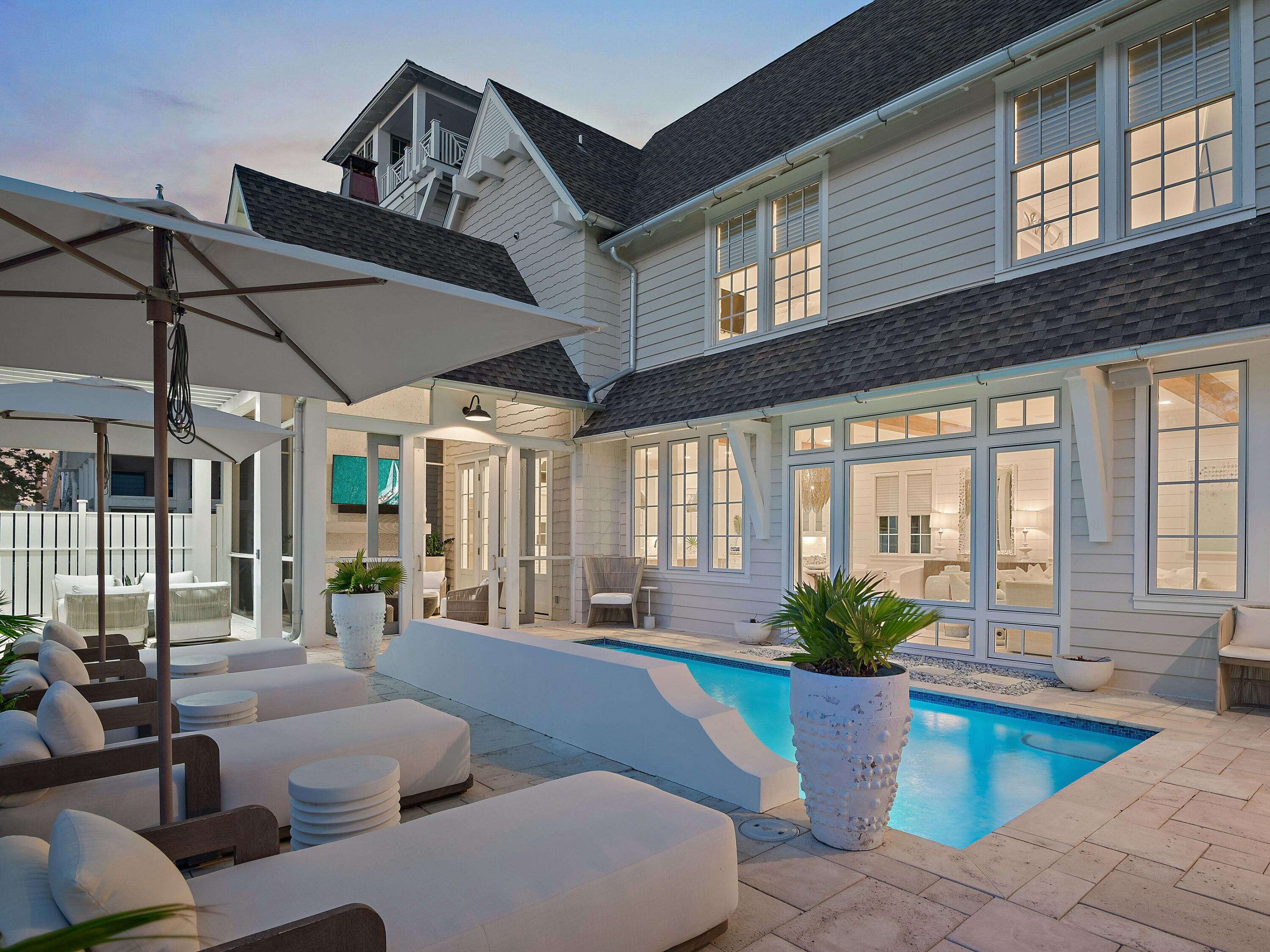 Welcome to 132 Grace Point Way, a masterfully designed coastal retreat that perfectly blends elevated architecture, privacy, and the effortless elegance of life along 30A. Nestled within the exclusive gates of Grace Point, this residence offers 5 bedrooms, 5.5 bathrooms, and more than 5,000 square feet of thoughtfully curated living space. Perched to capture sweeping Gulf views from multiple levels, the home also provides the rare privilege of direct private access into the Watersound Beach Club, placing world-class amenities and sugar-white sands just steps away.
Designed by TS Adams and completed in 2019, the home radiates timeless craftsmanship and modern coastal charm. Vaulted wood-beam ceilings, gleaming marble accents, and hand-selected finishes create a setting both refined and inviting. Every room has been furnished with the highest level of care, featuring luxury pieces from Palecek and Restoration Hardware, handmade light fixtures, and sumptuous linen bedding. Offered fully turn-key, even the artwork and custom details remain, ensuring a move-in ready experience curated for the highest level of luxury living.
Outdoors, the property was conceived with both privacy and indulgence in mind. A private heated pool with Gulf views anchors the backyard, seamlessly blending with the open-concept interior for true indoor-outdoor living. The exterior was refreshed in 2023 with a crisp Nantucket-inspired palette, complemented by upgraded landscaping, architectural lighting, a pet-friendly run, and an outdoor kitchen perfect for entertaining. Smart home features, a Sonos audio system, and a humidity-controlled garage further elevate the lifestyle.
Comfort is paramount, with two primary suites, a custom bunk room, and two additional bedrooms ensuring ample space for family and guests. A personal sauna, elevator servicing all three levels, and dual laundry rooms bring both luxury and convenience. The third-floor bonus room offers endless flexibility, whether envisioned as a media lounge, studio, or quiet retreat.
What truly sets this offering apart is its unparalleled location and access. Grace Point is a private, gated community with a dedicated owners' gate leading directly into the Watersound Beach Club. Here, members enjoy a resort-style experience unmatched along 30A, with two expansive zero-entry pools, over 1,000 feet of private sugar-white sand beach with full chair and umbrella service, and a selection of beachside dining venues including indoor and open-air options. The club also offers pickleball and tennis courts, a state-of-the-art wellness center, water sports such as paddleboarding and kayaking, and a calendar of member-only events designed to enrich every season. Whether you stroll home from a day at the beach or take a short golf-cart ride to nearby Camp Creek for a round of golf or spa-level fitness, life here is nothing short of extraordinary. 
132 Grace Point Way is more than a home, it is an invitation to a lifestyle defined by beauty, comfort, sweeping Gulf views, and the rare privilege of direct access to one of 30A's most coveted private beach clubs.