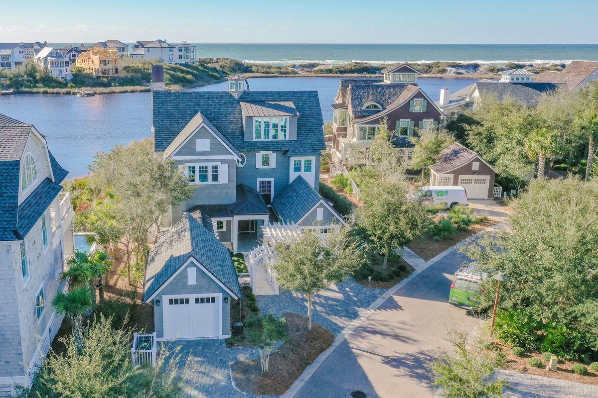 Set in the gated WaterSound Peninsula community, enjoy extraordinary views of Camp Creek Lake, the Gulf of Mexico and pristine dunes from this lake-front masterpiece with 67 feet of lakefront footage.  Built in 2016, the home was custom designed by TS Adams and built by Gulfview Construction with attention to every detail. Approaching the home through a picturesque courtyard with Dominican shell walkways, guests are greeted by a relaxing water feature, green arbor and a spacious covered porch. Upon entering the welcoming foyer, the first level contains a sitting area, 2 guest suites, and a well-appointed owner's suite. The pool and hot tub await just off the back porch. 4 porches encompass 1000 s.f. of viewing pleasure! Each guest suite contains a resort style bath, luxury furnishings, custom window coverings and fine linens. The main floor owner's suite has silk wall coverings, a private porch, custom porcelain fireplace, and spacious layout with large spa bathroom equipped with heated floors and custom closets. The first level includes a separate entry from one of two garages with a large laundry/mud room. The private elevator offers easy access to all 3 levels.  The 2nd level with its impressive views hosts the chef's kitchen appointed with Wolf and Subzero, a 6-burner cooktop, double oven, 2 dishwashers, ice maker, large walk-in pantry and wine refrigerator. The kitchen is open to the living and dining areas filled with natural light and enviable views. This living space is anchored by a custom Dominican shell stone fireplace framed by windows with sublime views. The living space continues via an oversized covered porch with professional grill, brick fireplace, and the most spectacular lake and gulf view combination 30A has to offer. The 2nd level also hosts a 2nd master suite currently functioning as the home office. The 3rd level encompasses a spectacular lounge area with stunning views, a large bunk room and bathroom. Plenty of parking and storage is available in 2 one-car garages. Technology abounds from exterior cameras, Control 4 home automation system, music system and smart TVs. WaterSound Beach is situated on 256 acres of natural sand dunes with over a mile of white sandy beach on the Gulf Coast. The property borders the protected Camp Creek Lake, one of the world's rare natural coastal dune lakes. Winding boardwalks and pedestrian bridges connect individual WaterSound homes with the beach, dunes, community pools.