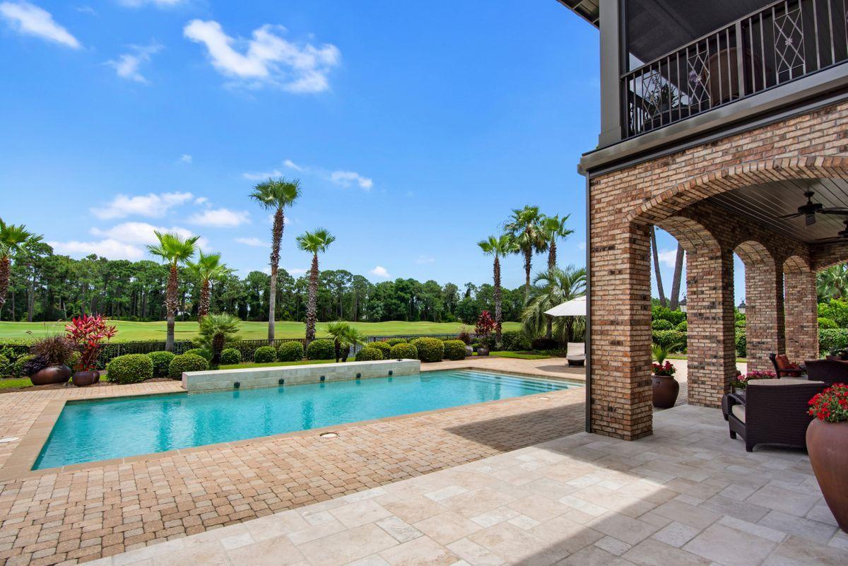 Designed by renowned architect Tom Christ and nestled within the gates of the Sandestin Golf and Beach Resort, this Burnt Pine estate is situated on over half an acre and offers lakefront and fairway views. This home features 5,716 sq. ft of living space and elegant finishes including custom lighting, limestone and hardwood floors, custom cabinetry, and a dramatic fireplace focal point. This is a bright and spacious home with high ceilings and an abundance of natural light. A great place for entertaining, this home offers surround sound, a wine chiller, multiple indoor and outdoor dining areas, and a gourmet kitchen with high-end appliances. Enjoy lake views from a large, covered back patio, or cool off in a private saltwater pool. The first floor also includes a master wing, as well as an additional bedroom. Three more bedrooms are located upstairs, and two of these feature private entrances to a second-floor balcony that overlooks the backyard. A three-car garage provides plenty of storage, and room for additional parking. The world renowned 2,400 acre Sandestin Golf and Beach Resort offers the ultimate in Florida living. With beautiful white sand beaches, four championship golf courses, a world class tennis complex, a 113 slip marina, and the pedestrian Village of Baytowne Wharf and Grand Boulevard with a full range of shopping, amenities, and dining.