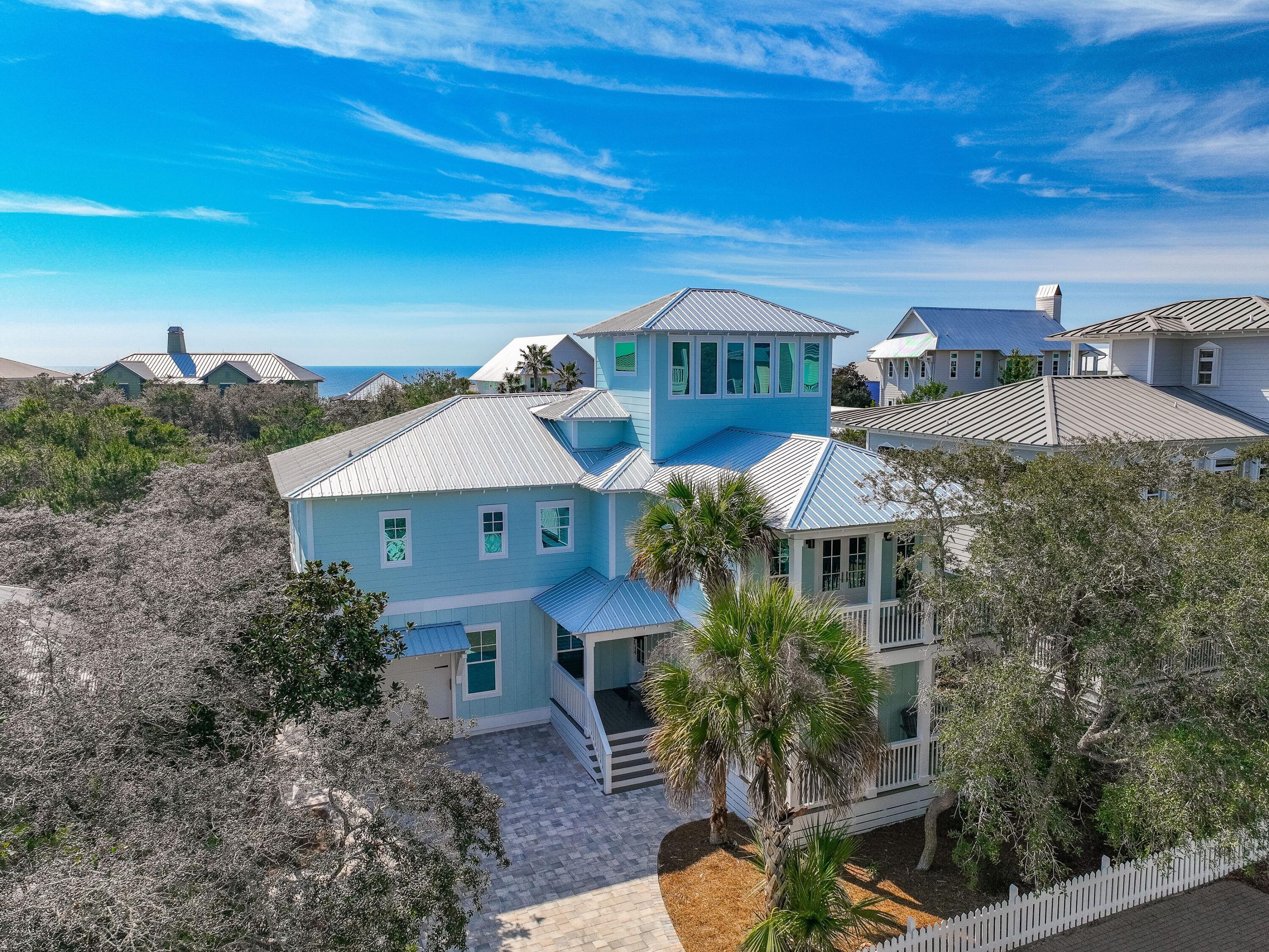 This newly renovated beach house is a beautiful five-bedroom home, steps from the pool and beach, featuring all new finishes, furniture and decor. This wonderful beach home underwent extensive upgrades and renovation in 2024 and has all the qualities you'd expect in a brand-new build. Everything from top to bottom was newly built, installed, finished and furnished.

Relaxation sets in as you enter the quiet, gated neighborhood, with brick-paver streets leading to your destination, under the shade of live oaks. You'll find ''Tidewater'' nestled on a quiet street, with palm trees, expansive decks and balconies, and comfortable parking for up to five vehicles. The home also features a one-car garage, which is ideal for storing extra beach gear and more. Three of the bedroom suites are located on this ground floor level. The junior master features a king-size bed, private access to the back porch, and a spacious bathroom with an amazing walk-in shower. The queen bedroom suite also includes private access to the balcony and a private bathroom with a walk-in shower. The bunk room features two queen-size bunks and three twin bunks, as well as a full bathroom with a tub and shower combo.

Moving up to the second floor, you'll find the main living space. The beautifully designed kitchen will be a favorite among the family's chefs. With plenty of seating at the kitchen island, the space is perfect for gathering together and spending time with the family while cooking. The dining space is adjacent to the kitchen, making meal time a breeze, with plenty of seating and a large, unique built-in plush bench running the full length of the wall.

Relax in the living room for movie night, or wander out through the full wall of sliding glass doors to enjoy the view. Take in gorgeous sunsets while relaxing in lounge chairs on the shaded balcony, which runs the full length of the home.

The master bedroom is also located on the second floor, just off the living room. This spacious suite features a king-size bed, beautiful views, and a huge master bathroom. Accent lighting automatically illuminates the floor as you walk into the bathroom, which includes an expansive dual vanity, large soaking tub and beautiful walk-in shower.

Just down the hallway from the kitchen on the second floor, you'll find another queen suite. This wonderful bedroom includes a private balcony overlooking the street, and a full-size bathroom (which can also be opened to the hallway to function as a common bathroom if preferred_.

Head up to the third-floor living room. With sweeping views in all directions, plenty of comfortable seating, a gaming table, TV and wet bar, this space is sure to be a favorite spot for your family. Enjoy amazing views for your sunset cocktails, gather for game night, or just escape with a book and settle into the comfy sofa for some quiet time. This well-thought-out and beautifully designed space is certainly a sight to behold.