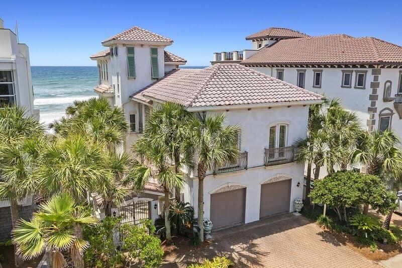 Your personal oasis on the Gulf awaits! From the moment you step inside, this home will captivate your senses with it's intricate architectural details, natural stone floors and Tuscan style columns. The two story library at the entrance sets the tone for the breathtaking views that await you in the stunning open concept living/dining area and adjoining kitchen. Every room in this home boasts great attention to detail, from the carefully planned layout, to the opulent décor, you will immediately feel like you have been transported to your own private villa. The owner's suite will take your breath away with it's very own separate sitting area/fireplace and TWO private bathrooms. The third floor has everything necessary to provide additional guests with an ultra private retreat.