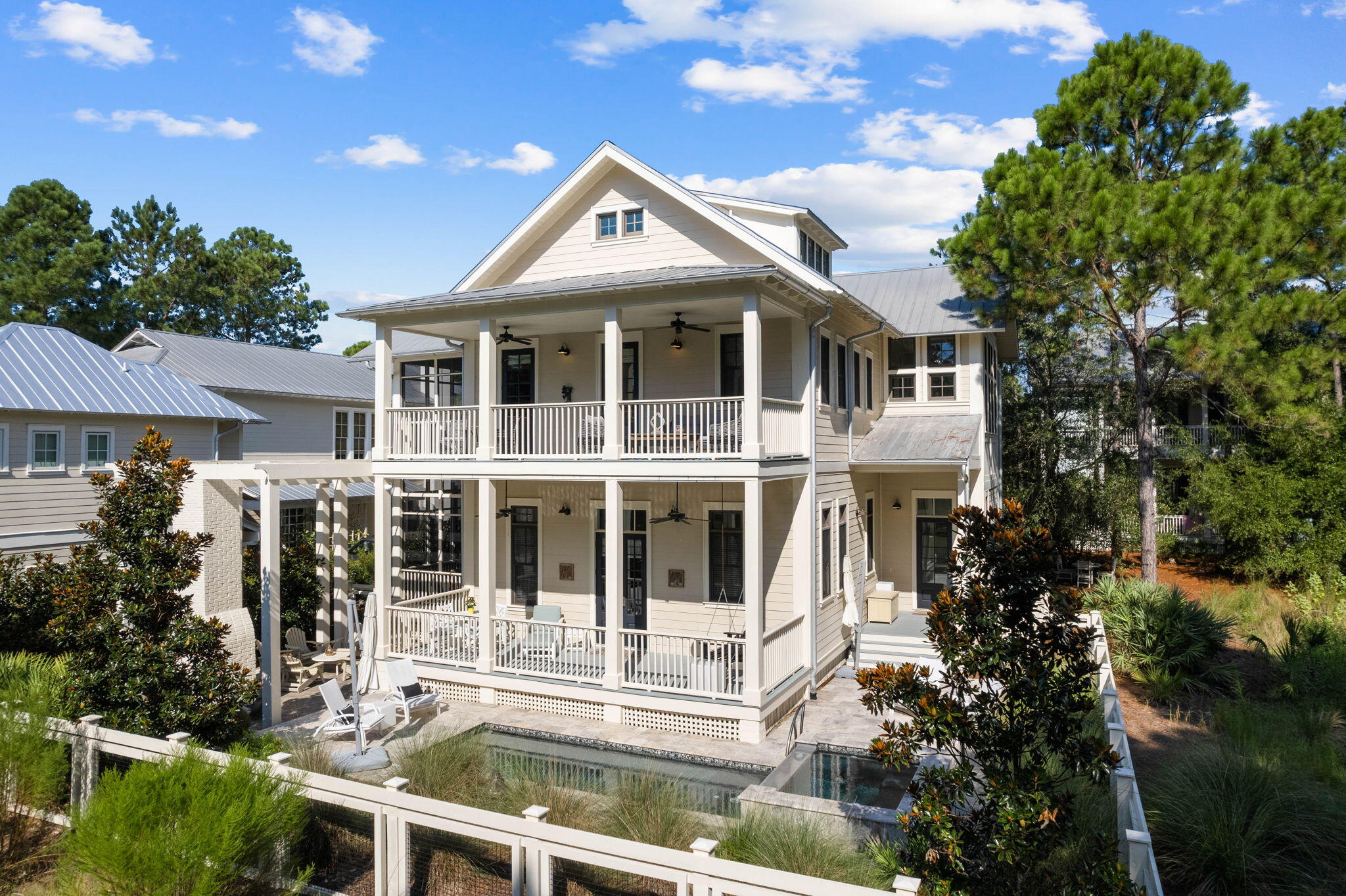 44 Crossvine Circle is prominently placed in the Camp District of Watercolor on the cul-de-sac of Crossvine Circle, just steps away from Camp WaterColor & Wood Fern Park. This home has been thoughtfully maintained and enjoyed by this family. The 3,848 Sq Ft, 5 Bedroom home boasts two primary suites, three king guest suites along with a private bunk room and 6 full baths! Beautifully appointed with luxury finishes, designer furnishing, chefs' kitchen, marble countertops, wire-brushed oak hardwood flooring and 12' ceilings. For the entertainer over 1,700 Sq Ft of additional porches & outdoor space including a heated pool, hot tub with ''chiller'' and stone decking just off the screen porch and the pergola covered outdoor fireplace with 6 Adirondack chairs makes this one of the many gathering spaces. This home is bordered by preserve forest on the side and back of the home providing considerable privacy and is offered fully furnished.