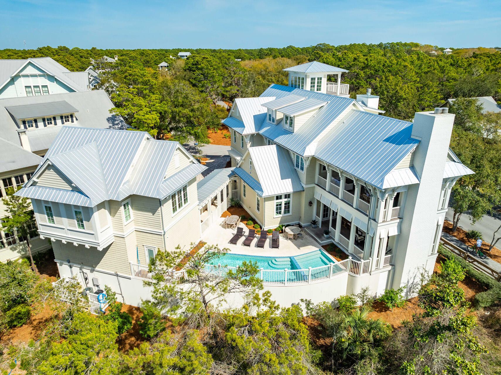 Nestled on one of the largest lots in the heart of WaterColor's sought-after Cottage District, 11 Dandelion Drive is the finest home in the community, offering six bedrooms, seven and a half bathrooms, and a private Carriage House. This stunning coastal retreat built by Borges Brooks Builders spans 6,081 square feet and blends classic architectural charm with modern luxury. Backing up to Western Lake, this home offers a serene natural setting with a trail behind the property leading to a community dock where residents can launch a paddleboard or kayak. Located just steps from Seaside and within walking distance to WaterColor's private beach club and multiple community pools, this residence provides the perfect balance of convenience and tranquility. Boasting one of the largest private pools and spas in WaterColor, as well as expansive outdoor living areas, this home is designed for relaxation and entertainment in an unmatched setting. As one of the highest rental performers in WaterColor, it generated over $418K in rental income in 2024, making it an exceptional investment opportunity. This property is offered fully furnished, ensuring a seamless transition for its next owner.

Upon entering, you are greeted by an inviting open-concept living space featuring rich hardwood floors, exposed wood beams, and an abundance of natural light. The spacious living room centers around a beautiful fireplace, creating a warm and welcoming atmosphere.

The adjacent gourmet kitchen is a chef's dream, featuring top-of-the-line appliances, custom cabinetry, a large island with ample seating, and a wet bar perfect for entertaining. A formal dining area offers space for gathering, while the breakfast bar provides a more casual dining option. The first floor also features a luxurious primary suite with an en-suite bathroom complete with a soaking tub and a walk-in shower, as well as a dedicated laundry room for added convenience.

The second level offers a cozy sitting area with a wet bar, ideal for a secondary lounge space. Three well-appointed bedrooms provide comfortable accommodations, including a primary suite with private access to a covered porch. A guest suite with a king bed and additional bunk space, as well as another king bedroom, both offer private en-suite bathrooms.

On the third floor, a spacious recreation room features a game area with multiple TVs and a ping pong table, providing the perfect setting for entertainment. A versatile guest bedroom on this level includes a king bed, a twin bed, and additional bunk space, making it ideal for larger groups or families.

A true highlight of this home is the fourth-floor lookout tower, offering breathtaking views of WaterColor and the surrounding area. This unique feature adds to the charm and character of this exceptional residence.

Outdoor living is at the forefront of this home's design, with expansive covered porches featuring gas fireplaces and plenty of seating for relaxation or entertaining. The oversized private pool and spa create a tranquil retreat, while the spacious patio allows for alfresco dining and unwinding after a day at the beach.

The separate Carriage House provides additional living space with a full kitchen, a comfortable living area, and a private guest suite, making it an excellent option for visitors or extended family stays.

Situated in one of the most desirable locations along 30A, this remarkable home offers access to WaterColor's world-class amenities, including tennis courts, pickleball courts, nature trails, lush parks, and a private beach area. With its prime location near Seaside, charming boutiques, and fine dining, 11 Dandelion Drive presents a rare opportunity to own a luxurious coastal residence in one of the most prestigious communities on Florida's Emerald Coast. Contact us today to schedule a private viewing of this extraordinary home.