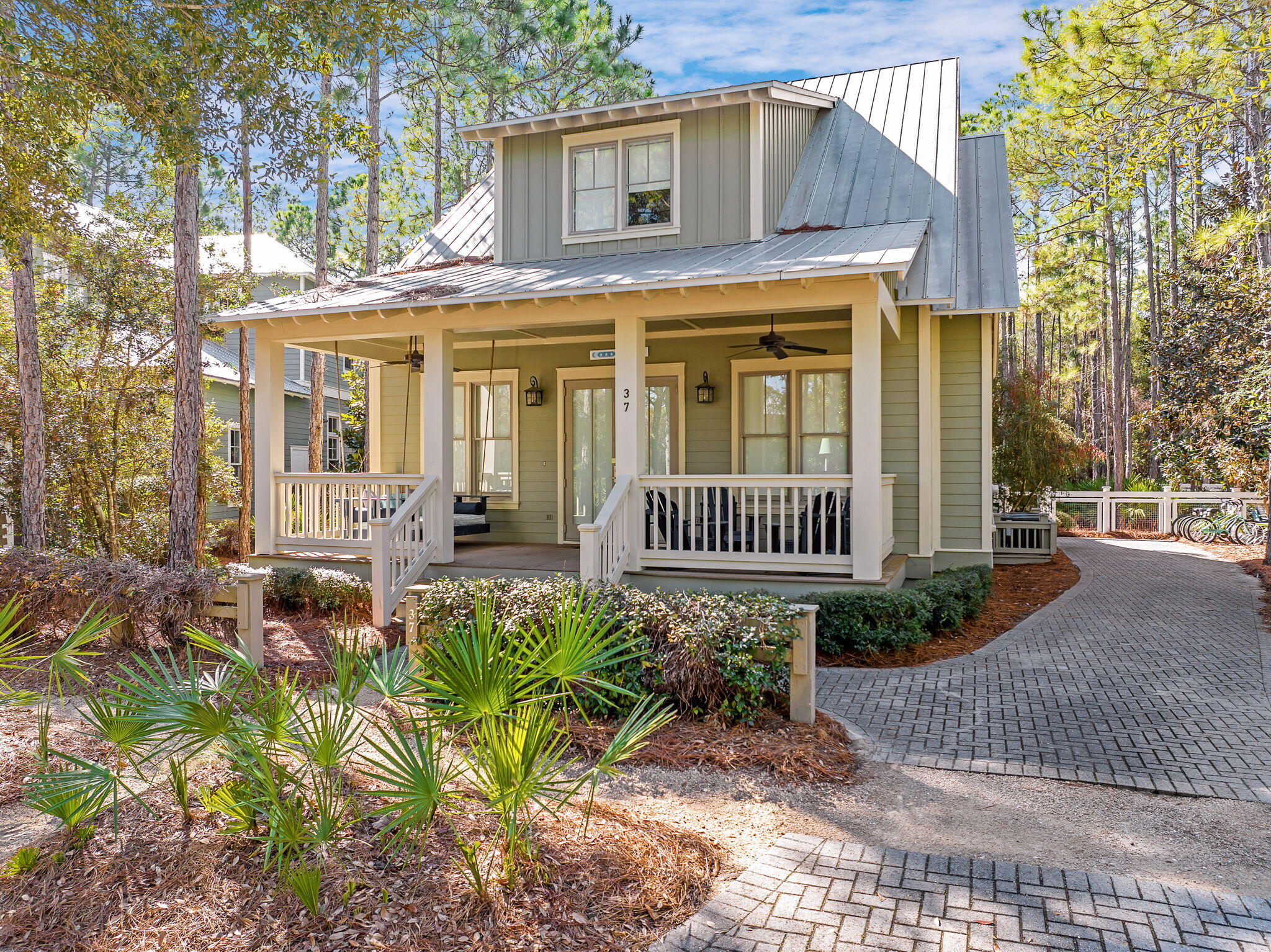 Welcome to your dream coastal retreat in the heart of WaterColor, Florida! 37 Royal Fern Way is situated on an expansive lot in WaterColor, the property offers a unique opportunity to add significant value. There is ample room to construct a garage and a charming carriage house, enhancing both functionality and property value. The home features a large front porch with a cozy swing bed, perfect for enjoying the coastal breeze. The expansive back porch provides additional outdoor living space, ideal for dining al fresco or relaxing after a day at the beach. This property offers your own private oasis as you will enjoy the luxury of having one of the largest private pools in WaterColor right in your backyard, a perfect spot for relaxation and entertaining. The adjacent hot tub offers a  serene place to unwind, while the outdoor shower adds convenience after beach outings. With a peaceful setting, the property backs onto a tranquil wooded area, providing privacy and a picturesque natural backdrop. This exquisite 4-bedroom, 3.5-bathroom beach house offers the perfect blend of luxury, comfort, and potential for future enhancements. WaterColor is a highly sought-after vacation destination, and this property has a strong track record of rental income. Investing in this home not only provides a luxurious personal retreat but also offers the opportunity for substantial rental revenue. With four generously sized bedrooms including a first-floor mini master suite with an ensuite bath, a second floor master suite with large master bath to include a water closet, dual vanities, a soaking tub and stand-alone shower, an additional 2nd floor guest bedroom and a dedicated bunkroom that comfortably accommodates six, making this property perfect for hosting additional guests or creating a fun space for children and a 3rd full bathroom completes the upstairs. This 2,362 square foot home provides ample space for family and guests. The residence boasts high ceilings and gleaming wood floors throughout, creating an airy and inviting atmosphere. The home's design emphasizes natural light, creating bright and cheerful living spaces.  Culinary enthusiasts will appreciate the modern kitchen equipped with granite countertops and stainless steel appliances, a central work island, and a breakfast bar, ideal for casual dining and entertaining. For more formal gatherings, the home features a dedicated dining room that offers a refined space to host family dinners and celebrations. This residence is being sold fully furnished, allowing you to move in and start enjoying the WaterColor lifestyle immediately. This property is located in the resort neighborhood of Watercolor, nestled between the stunning Gulf coastline and serene Western Lake. WaterColor offers a unique blend of beach and lakefront living and is renowned for its beautifully preserved natural landscapes. As a resident of WaterColor, you will have access to an array of exceptional upscale amenities. WaterColor is home to 9 community pools, including three offering unobstructed Gulf views at the Watercolor Beach Club and three at Camp WaterColor featuring two pools with slides, a lazy river, playground, and basketball court. Throughout Watercolor you will find 5 miles of hiking and biking trails, multiple park areas and several docks that are great to let the kids fish in. The community is designed to have a small-town feel and is perfect for exploring on foot or by bike. Quaint streets and pathways connect homes to the community's parks, lush green spaces and shops. Resident also have access to both tennis and pickle ball courts and a pro shop with tennis gear. Private lessons, group clinics and other activities are available throughout the year. The community also includes access to a boathouse on Western Lake with paddle boards, kayaks and fishing equipment; an outdoor amphitheater; a lakeside pool; and a bike barn. This property is more than just a home; it is an opportunity to embrace the coveted WaterColor lifestyle while adding your personal touch. Don't miss the chance to make this exceptional beach house your own!