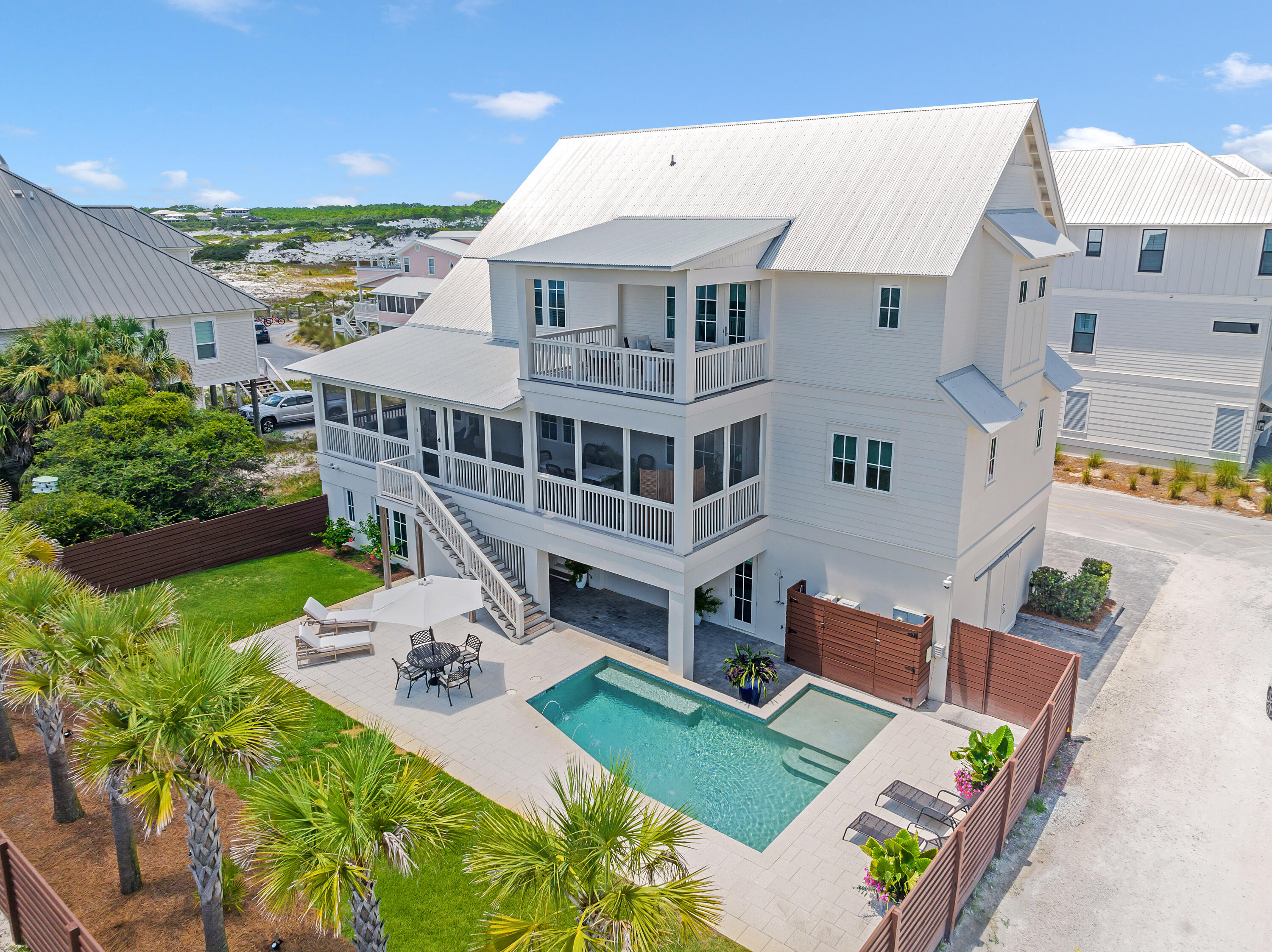 Prominent Grayton Beach five bedroom, five bath  and two half baths is just steps away from one of the most renowned beaches and beach walkover in Florida. It's remarkably designed and customized on a corner lot, spacious yard, private pool, guest quarters, and its eye-catching gulf views. This guest apartment suite on the ground level is accessed by a private entrance and has additional parking. The second floor features a spacious living area with beautiful exposed wood beams, custom barn doors, and saw-cut hardwood flooring, reflecting the natural environment. Three contemporary pendant lights are the focal point over the open boastful chef's kitchen that comes fully equipped with a 48-in. six-burner Wolf gas stove, cool marble countertops and a floor-to-ceiling wine refrigerator. Doors open onto a 12'-ft. full-width deck that leads to your own private oasis outdoors. Head up to the third floor for sunset drinks in the covered lookout. The magnificent master suite boasts airy vaulted ceilings, oversized double vanities, an enormous spa-like shower, and spacious walk-in closet. A perfect start to the day is on the adjoining private porch with serene views of the gulf and Grayton Beach State Park. The white sandy beach and state park offer a host of recreation on the doorstep including paddle boarding and birding at Western Lake, a rare coastal dune lake. A perfect respite for a full-time, secondary, or rental investment.

**Furnished ** exclusions are: all artwork and blue porcelain dishes do not convey