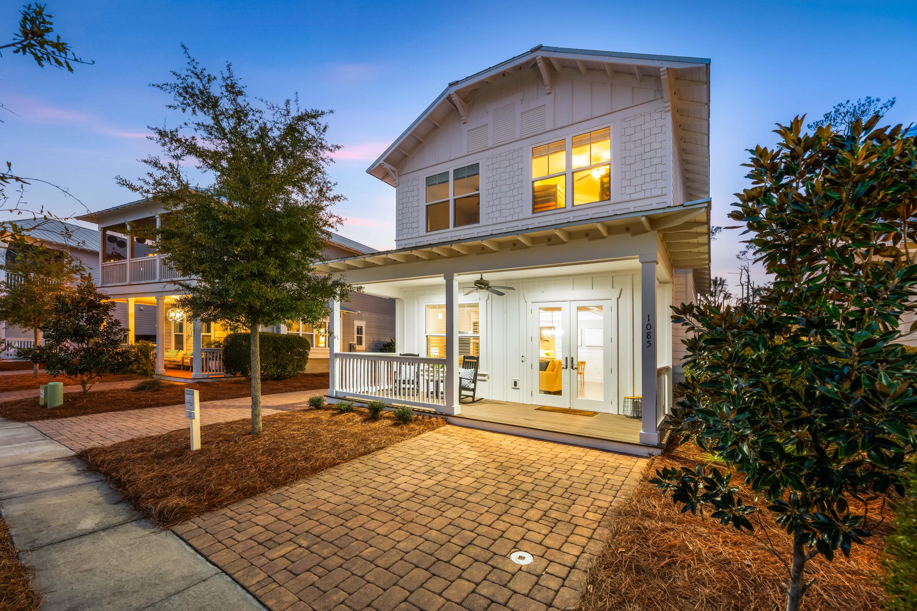 MOTIVATED SELLER! ACCEPTABLE OFFERS WELCOMED! This beautifully appointed four-bedroom, three-and-a-half bath, two-story home offers one of the most sought-after floor plans in the NatureWalk community. Hardwood floors and shiplap paneling flow throughout the home, creating a warm, coastal-inspired aesthetic. The spacious kitchen features an oversized island and a dedicated sitting area, perfect for casual dining and entertaining, and opens into a large, light-filled family room ideal for gatherings.
The home features two covered porches and one of the longest driveways in the neighborhood. The backyard offers ample room for a future pool and backs directly onto the National State Forest, providing a peaceful, private backdrop. Offered fully furnished, this home allows for an effortless move-in or rental opportunity. Residents enjoy access to the community pool, playground, grilling area, and scenic nature trails, along with a convenient 1.25-mile bike or walk to the beachdelivering the perfect blend of comfort, recreation, and coastal living.