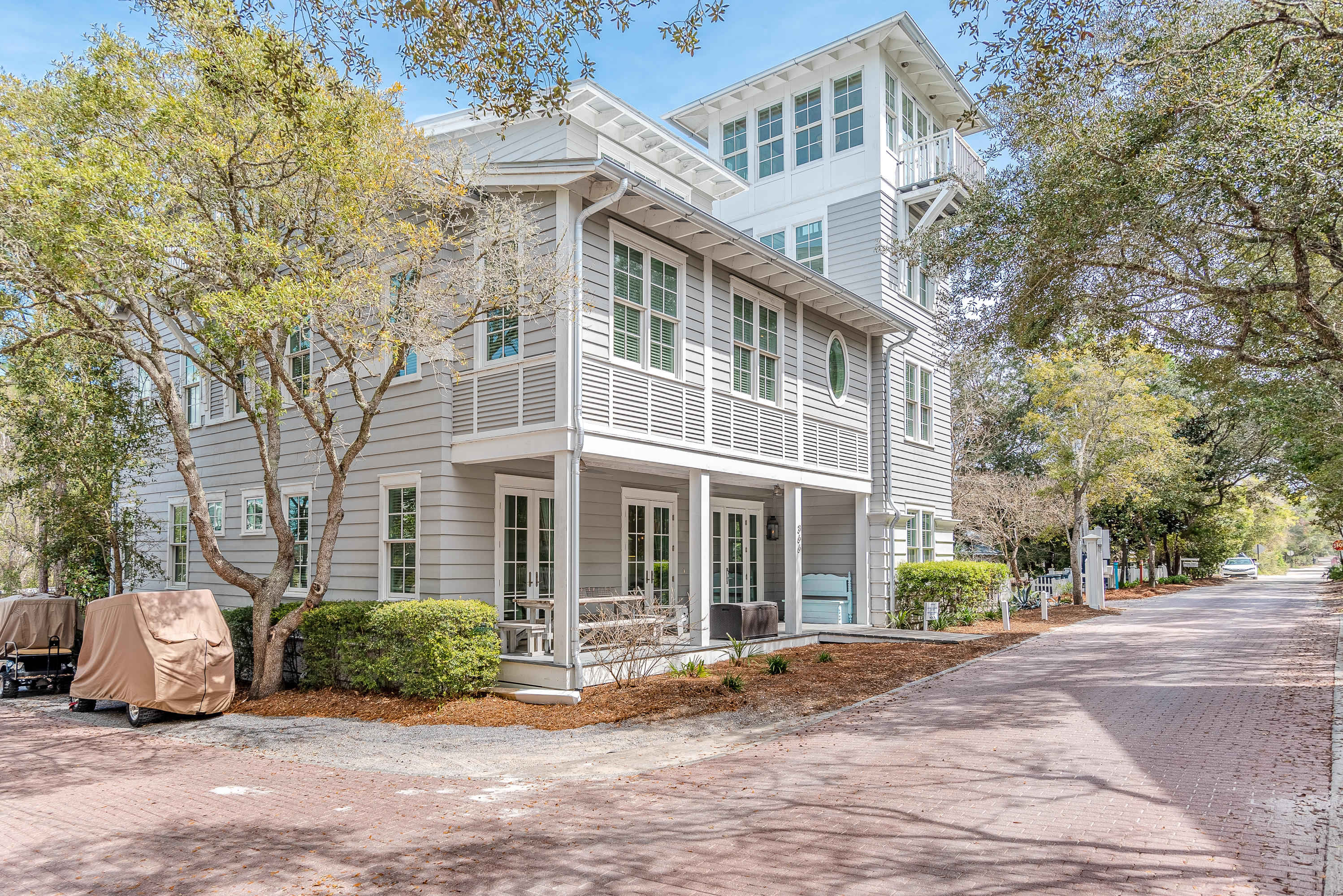 'HAPPY OUR!'  Got a big family who loves the beach? Well here's your golden opportunity to own one of the few homes in SEASIDE large enough to accommodate everyone! This is the beach home that will stay in the family for generations to come. Being located near the recreational area provides a more peaceful atmosphere, yet  just a stones throw away are two heated pools, fitness center, tennis courts, croquet lawn, playground and more. Head the opposite direction and it's a quick stroll to the beach through the iconic Tupelo Pavilion.
The front porch, softly lit by gas lamps, beckons a very Southern sit-down & stay-awhile approach.  Upon entering the home, you're greeted with a delightful open floor plan so popular at the beach. Three sets of French doors and numerous windows flood the family areas with plenty of natural light.  A gas fireplace serves as the focal point for the living room, while the kitchen is designed to be the hub of the home.  Sporting cultured marble countertops, the gourmet kitchen is furnished with all stainless-steel commercial grade appliances including oversized side-by-side Sub-Zero refrigerator,  Wolf 48" dual fuel gas range, Wolf espresso/cappuccino coffee station, and Frigidaire built-in microwave.  A cleverly designed breakfast nook seats four, while the dining-bar accommodates another five, in addition to the dining table.   The home offers two master bedrooms with luxurious en-suite baths, one of which is located on the first floor.  Laundry facilities and a half-bath complete the first level.
  
The second floor provides another glorious master suite and three more bedrooms  all with en-suite baths.   Custom marble and tile have been used generously in all bathrooms.  You'll also find a sunken Jacuzzi tub, claw foot tub, oversized showers, and huge walk-in closets.  The entire third floor is reserved for entertainment!  A spacious common area provides a TV/den-like retreat, large table for board games, a nautical inspired bunk room that sleeps six (each bunk has their own TV),  full bath, wet bar, and two precious "cubbies" that are bound to become his and hers "kid caves."  The 'stacked' tower provides another place to curl up with a good book, while the spiral stairs lift you to the fourth-floor tower with beautiful views of Seaside sunsets. 

Additional details in this magnificent home include 7" hardwood floors stained a warm glow, extra tall ceiling heights finished with crown molding, pecky cypress accents, Sonos wireless sound system, Nest thermostats controlled by your smart phone, and exterior security cameras.  Three on-site parking spaces are a bonus!