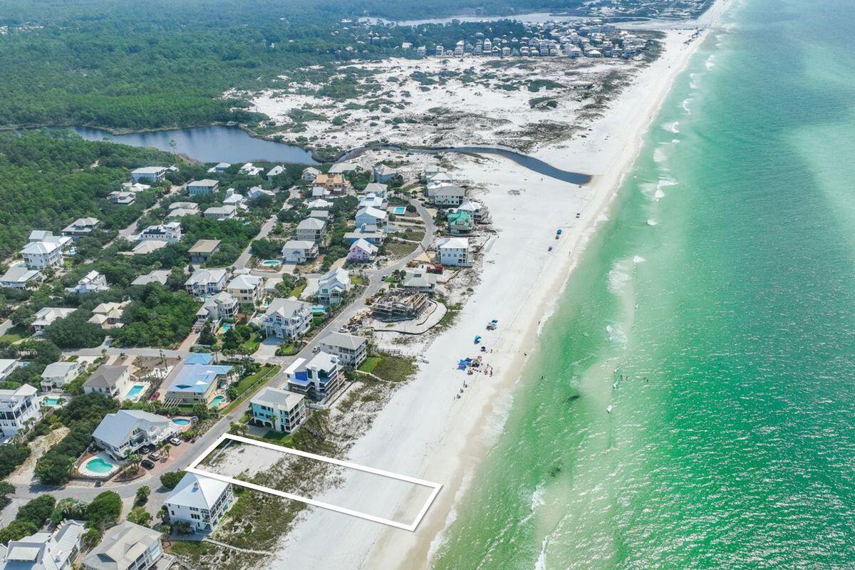 Nestled in the secluded community of Gulf Trace in Grayton Beach, this expansive lot boasts an impressive 80 feet of gulf frontage, extending right down to the waterline. Imagine waking up to the soothing sounds of the gulf, just steps away from your doorstep. With house plans available for a unique 3,577-sq.-ft. duplex — each side featuring its own petite pool and connected solely by stairs — your investment choices are flexible. Opt to build the duplex or go the route of a single-family home; either way, you're constructing a lifestyle that's the epitome of coastal luxury. This rare lot is situated in a tight-knit neighborhood consisting of only 82 homes, making it a tranquil enclave in a much-desired locale. Gulf Trace is uniquely bordered by Grayton Beach State Park and scenic coastal dune lakes on three sides, creating a serene natural buffer that enhances privacy and tranquility. Convenience isn't compromised for seclusion; you're within walking distance of everything Grayton Beach has to offer. Whether it's shopping, dining, or entertainment, it's all easily accessible. This is one of only three lots offering such extensive linear footage along the gulf across the entire 30A corridor, elevating its exclusivity. Here, you're not just buying land; you're securing a coastal paradise.