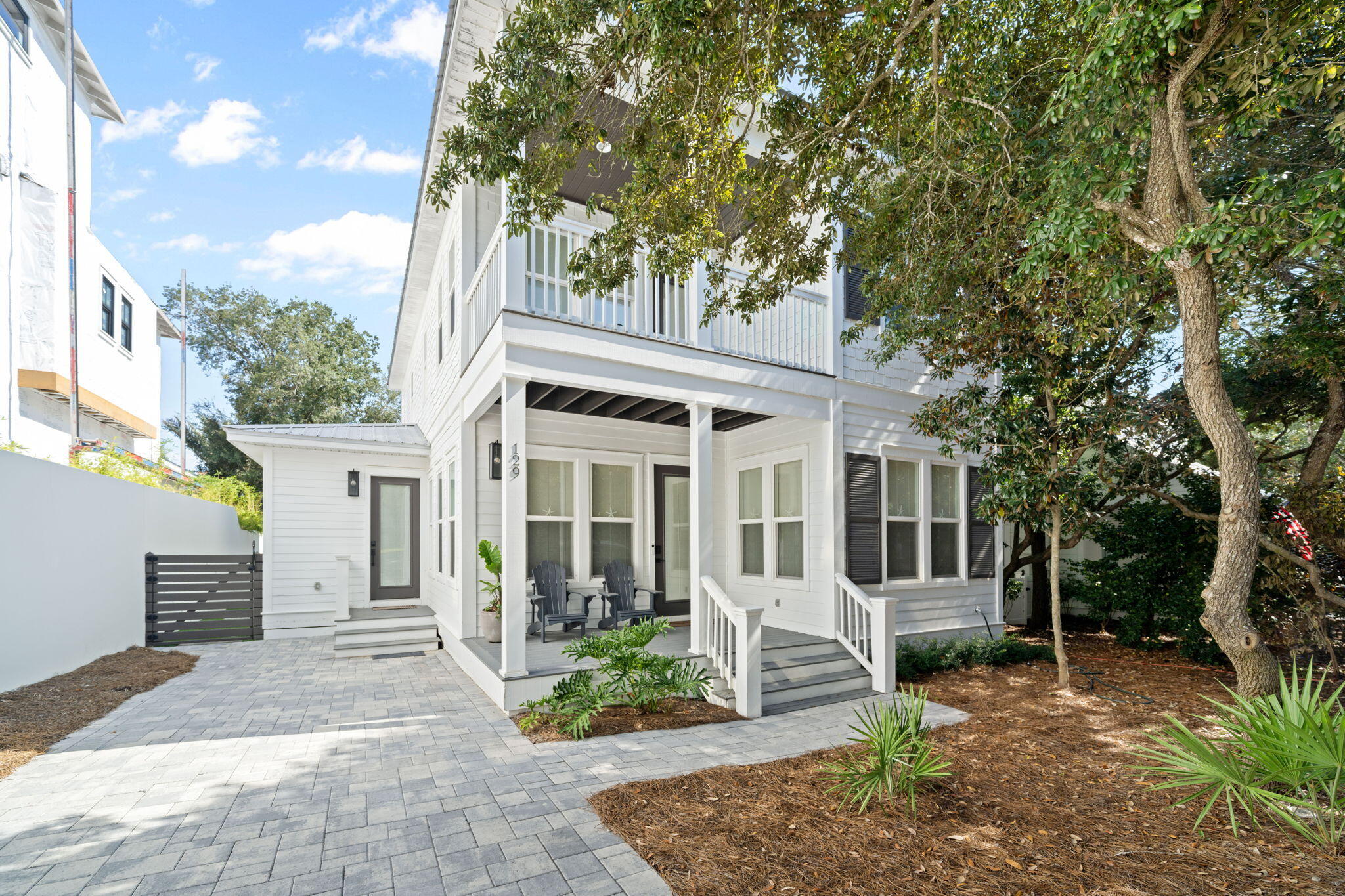 Completely remodeled in 2022, this beautifully updated beach home is just one block from the gulf and embodies the relaxed yet vibrant 30A lifestyle. Spend your days biking, strolling, shopping local boutiques, dining at neighborhood restaurants, or soaking up the sun on the beach—then return to your own private retreat complete with a sparkling pool and elegant interiors.  Inside, the heart of the home is the open-concept kitchen, dining, and gathering area. A striking quartzite and stone island pairs seamlessly with high-end Dacor stainless steel appliances, setting the stage for effortless entertaining. The newly added mudroom, equipped with washer and dryer, makes coming home from the beach a breeze. Durable light-toned luxury vinyl plank flooring flows throughout the first floor, while soft carpeting enhances the comfort of the second story. A dedicated bunk room ensures plenty of sleeping space for kids and guests, plus having a master bedroom on both floors makes this home ideal for families or rental potential.  Outdoor living was designed with both relaxation and entertaining in mind. A screened-in porch features an outdoor kitchen, while the backyard offers a grill station and a completely resurfaced pool with new gunite, coping, heater, and equipment. Additional improvements include a new driveway and back patio.  Whether you're seeking a full-time residence, vacation getaway, or investment property, this Old Seagrove gem delivers the best of coastal living just steps from the Gulf.  With county beach access just a short walk away, 129 E Grove Ave makes it easy to enjoy one of the area's most pristine stretches of shoreline.