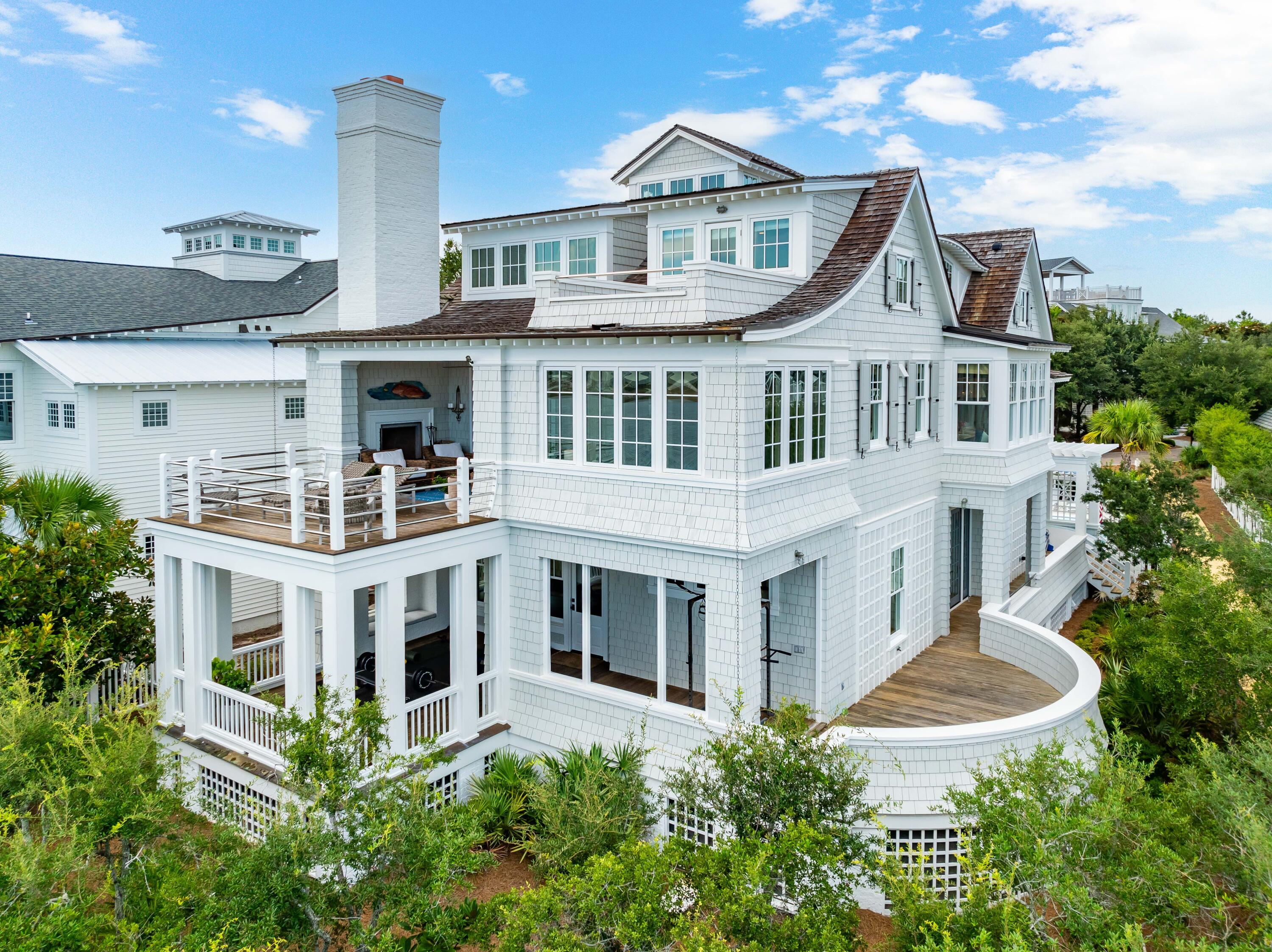 Introducing 109 Gulf Bridge, a prestigious home overlooking Camp Creek Coastal Dune Lake and the Gulf of Mexico beyond. Situated on a generous corner lot in Watersound Peninsula, it offers unparalleled views and expert craftsmanship with thoughtful details, plus easy beach-access + amenities. 

Entering through the courtyard, find a newly added pool and astroturf landscaping that leads to a large front porch complete with outdoor shower. Inside on the first floor, enjoy 3 guest rooms with ensuite bathrooms, alongside a thoughtfully designed laundry room, second living area, and back porch that's fashioned into an outdoor workout room. Upstairs, enjoy picturesque views from nearly every direction. A living room  complete with soaring ceilings, grand fireplace and built-in window seats and bookshelves  opens to a newly updated chef's kitchen, sunny sitting room, and large porch. Off the kitchen, find a dining room with its own coastal dune lake views. Down the hall, enter the primary suite, which features two separate closets and a beautiful ensuite bathroom with walk-in shower, water closet, dual vanities, and spa-like tub. 

On the third floor, enjoy bird's eye views from a built-in office space, flex space, and balcony. 

Craftsmanship and luxury detailing prevails across all three stories, with ample woodworking details and designer finishes that complement the quintessential Watersound Beach styling. With a dumbwaiter, built-in storage, multiple living spaces, one-car garage, driveway parking for multiple vehicles, back-door access to a lakefront trail, and unobstructed views, 109 Gulf Bridge is a unique opportunity and must-see.
