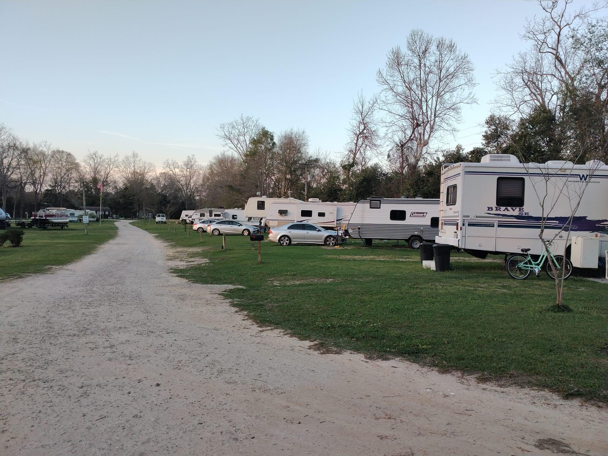 *Owner Finance Available* Turnkey, income-producing RV park on nearly 6 treed acres with pecan, sycamore & oak trees. Features 23 RV sites (each with separate electric meters), 1 fully rented tiny home, and an 1,100 sq. ft. on-site manager's home. 8 long-term tenants on month-to-month leases provide steady, flexible income. Infrastructure includes crushed concrete roads, loop water system, 4 septic tanks & underground utilities. Amenities: spring-fed pond, 3 picnic areas, coin laundry, fiber internet & security cameras. Low-maintenance, high-potential investment with expansion opportunity. Investors--bring all offers!