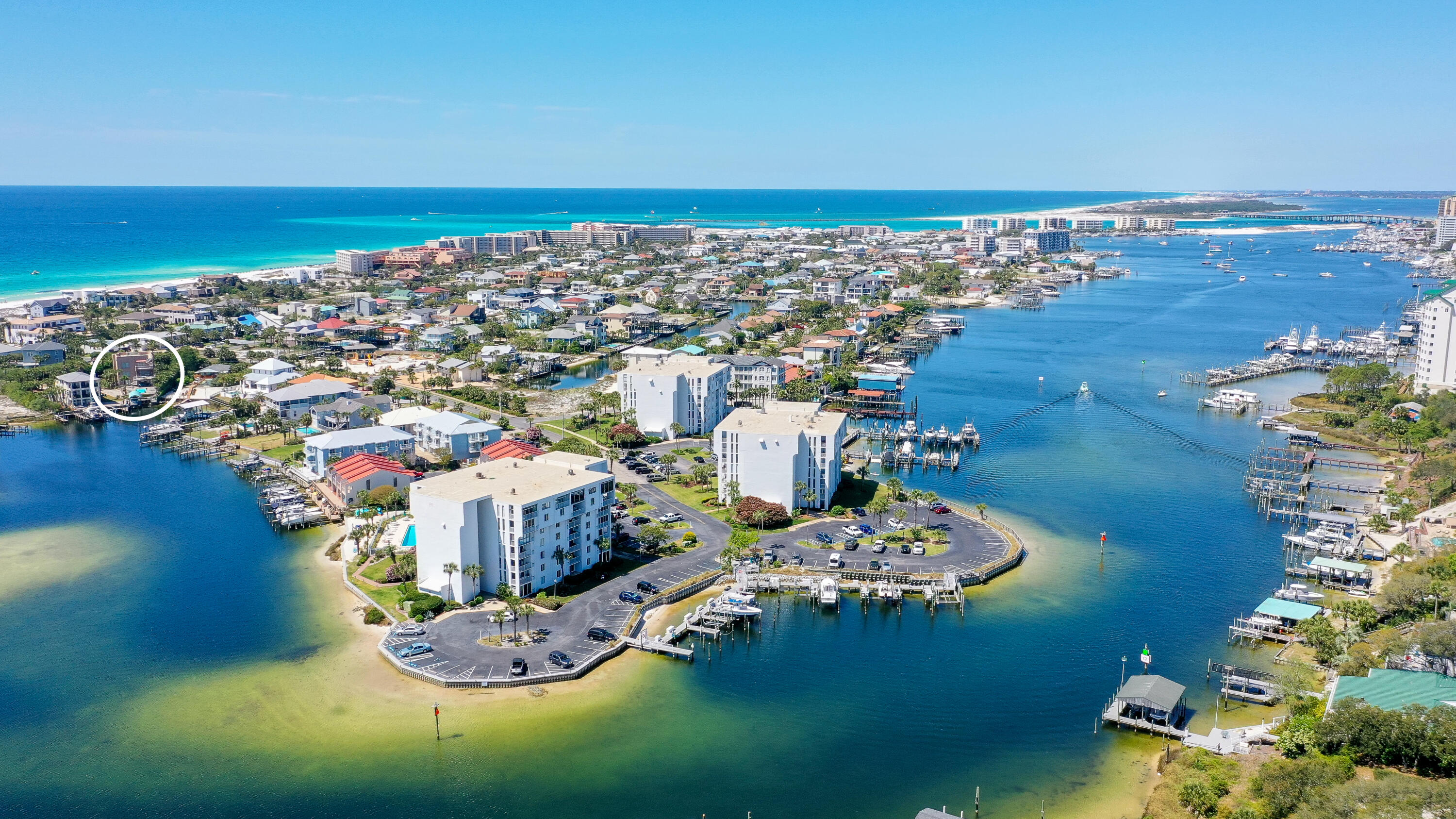 This unique home is truly one of a kind, from the open entertaining spaces, rooftop deck with gulf views and high-end finishes to the oversized pool and boat dock with lift on the Destin Harbor and walking distance to the beach. It is a private retreat that truly has everything and more needed as a home or income producing property all in a highly desirable location. This luxurious and sleek 3 bedroom, 4 bath, 3-story home has over 3590 square feet of living space and sweeping views of the harbor. Each floor has been designed for optimal enjoyment while capturing and highlighting the beautiful surroundings. The main entrance into the home on the 2nd floor opens to the living area, which has a fireplace, built in entertainment center, cocktail bar with ice maker, game table, large dining room with mahogany walls, plus a half bath. The gourmet kitchen features a Sub-Zero refrigerator, Miele Steamer Oven, Gaggenau double oven, gas and electric cooktop with pot filler, Bosch dishwasher, and extended counter-top with stools.  The entire 3rd floor is a master suite with a morning kitchen, large walk-in closet with safe room, built-in office, fireplace, uniquely styled soaking tub, large shower with harbor views and hidden away washer and dryer. Imagine watching dolphins play while you shower! From the third floor balcony you can walk up the spiral staircase to the roof top deck which features 360 degree views of the gulf and harbor  the best place to watch the sunrise or set in Destin will be from your own rooftop terrace. The rooftop terrace is pre-wired for a hot tub, and would be an amazing setting for an outdoor lounge with seating and outdoor kitchen. The first floor contains a guest suite with living room, full bath and direct access to the pool and harbor.  Also on the first floor is a captain's quarters or third bedroom with private entrance from the pool veranda, full bath and separate AC unit. The oversized garage plus work area is spacious for all the cars and toys. This home also boasts an elevator with access to all three floors, three AC units, sprinkler system on reclaimed water, jet ski lift, outdoor speakers, and sound system throughout the whole house. The outside includes a covered lounge area, 14×30 rectangular shaped pool, HOA deeded beach access with golf cart parking, and two deep water boat slips one covered with a lift and the other able to accommodate up to an 80 ft yacht.   All of this is hidden behind palm trees just for you and your friends and family to enjoy.

*Home is sold AS-IS furnished minus linens. 
*Buyer to verify all dimensions and measurements.