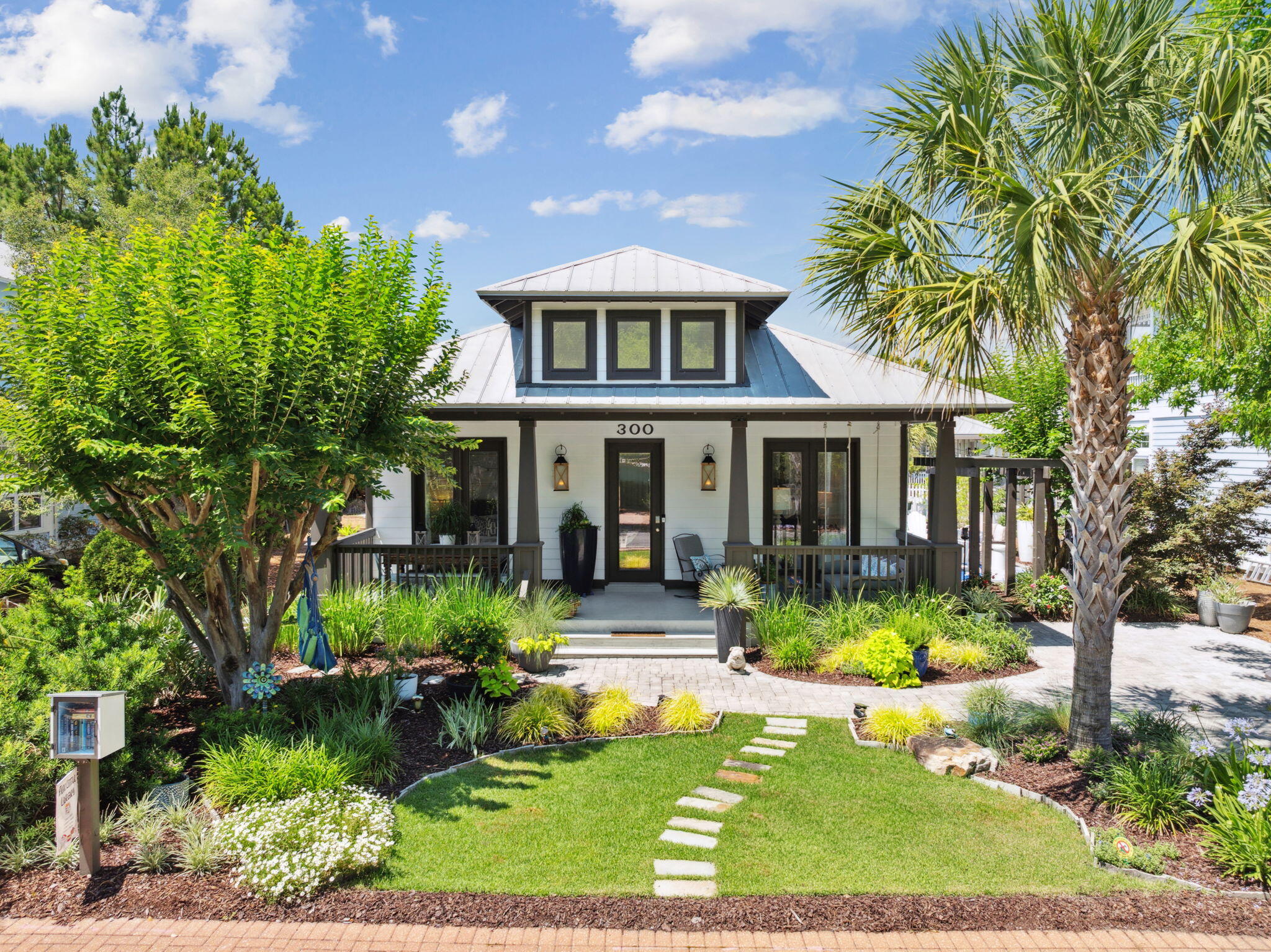 Tucked away in the highly desirable Cassine Village community in Seagrove Beach, this fully renovated 3-bedroom, 2-bath coastal retreat is a rare find along 30A. Offering 1,461 square feet of thoughtfully updated living space, this home stands apart with custom hardwood floors, an updated exterior, and vibrant, well-maintained landscaping that adds to its inviting curb appeal.

Inside, the home features a bright, open layout with high ceilings and excellent flow throughout, creating a spacious yet comfortable atmosphere. It comes tastefully furnished in a relaxed coastal style (with most furnishings conveying), and both bathrooms have been beautifully updated with finishes that elevate the overall design.

The master suite is a true highlight--generously sized and is a great place to unwind at the end of the day. The tastefully renovated en-suite bathroom features coastal-inspired finishes and carefully chosen details that create a relaxing, functional space. A spacious walk-in closet provides ample storage and organization. The two additional bedrooms are equally inviting, perfect for guests or family, and share a beautifully updated full bath with a fresh, coastal design. 

The living areas transition seamlessly to multiple outdoor spaces each uniquely designed for comfort and connection. The charming front porch features a cozy swing and an outdoor dining area, perfect for slow mornings or sunset meals. The back porch offers a more private setting with a comfortable sitting area and an outdoor TV ideal for watching the game or relaxing with a movie. The side yard adds yet another gathering space, providing a versatile area for entertaining, games, or simply soaking up the Florida sunshine. 

Recent updates include all new windows and glass door panes, spray foam insulation in the attic for enhanced energy efficiency and climate control, and relatively new water heater (2022) and the A/C replacements was replaced in 2018. The attic also offers abundant storage space perfect for beach gear, seasonal décor, or anything you'd like to keep tucked away. The yard has a timer-scheduled sprinkler system that is controlled via an app (9 zones - covers 99% of plants and grass) and LiveOak fiber was just installed (2026). Two private driveways one in the front and one in the back offer rare parking for five to six vehicles. 

Cassine Village is known for its quiet charm, low HOA fees, and unbeatable location just minutes from one of 30A's convenient public beach accesses. Residents enjoy access to two community pools, as well as pickleball and tennis courts. Whether you're looking for a full-time home, vacation getaway, or investment property, this turn-key gem offers timeless appeal, thoughtful upgrades, and coastal comfort in one of 30A's most beloved neighborhoods.