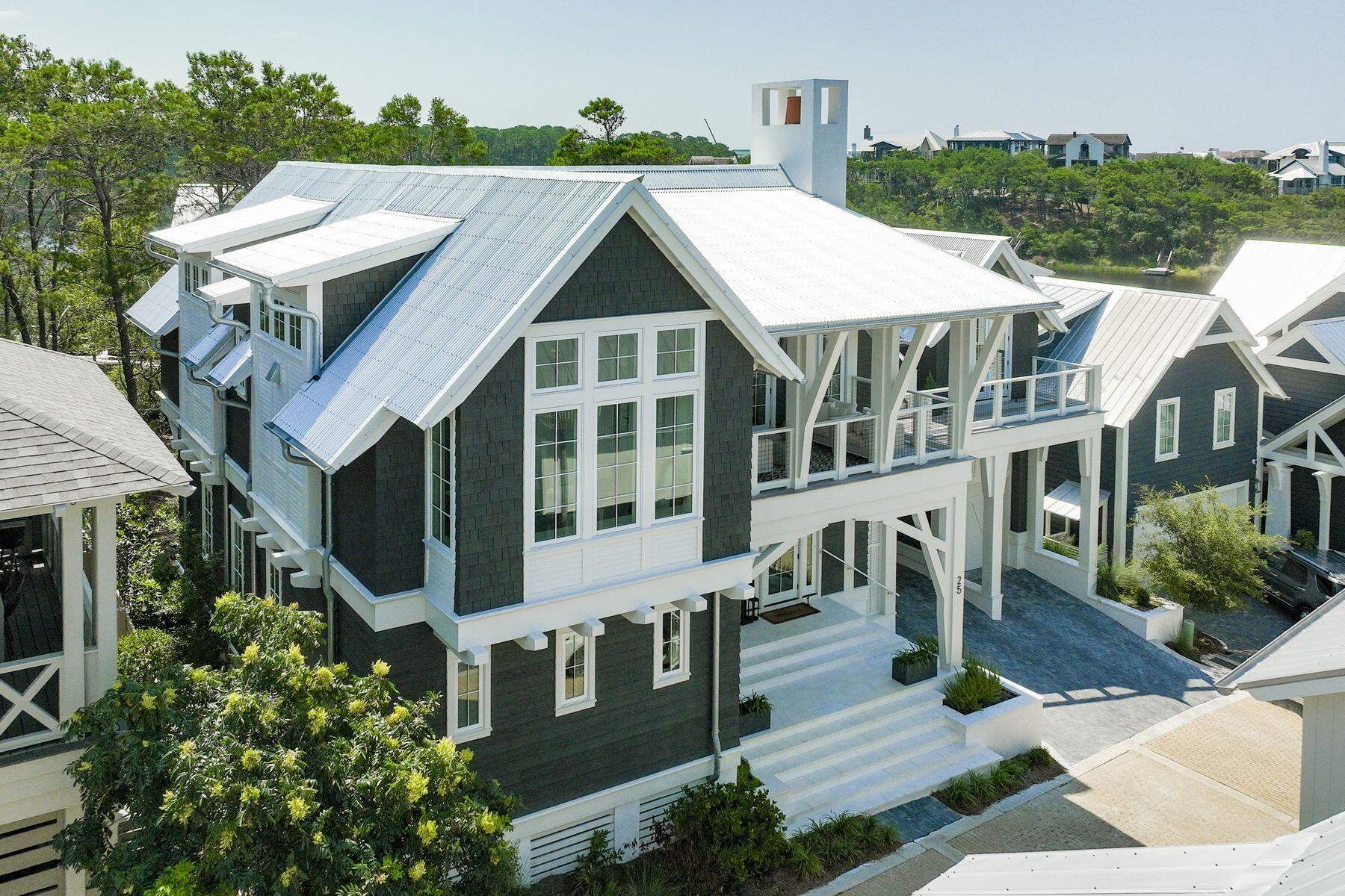 This newly-built stunner in the gated and private Draper Lake Coastal Village wont last long! 25 Bluff Lane is sold fully furnished and offers rare Gulf and coastal dune lake views. The home features an expansive 3,174 square feet of living space that boasts five beds, five full baths and two half baths. The floor plan offers multiple living spaces and a semi-detached carriage house wrapped in multiple cantilevered porches. Exquisite finishes have been carefully curated to deliver a thoughtful design experience. An outdoor living terrace with a summer living terrace with a summer kitchen that anchors an entertaining space that is both functional for entertaining and smartly conceived for relaxation. A combined garage and carport provide room for four vehicles, multiple bicycles and... beach toys. Draper Lake Coastal Village offers numerous luxurious amenities including community pools, boathouses, bridges and boardwalks that wind through its tranquil setting, gated entry and a 48-feet observation tower that overlooks the community. This rare opportunity is an ideal primary residence or vacation retreat for those who wish to be near 30A's many boutiques and restaurants while maintaining a sense of solitude amid a natural backdrop. Call today while this rare opportunity lasts.