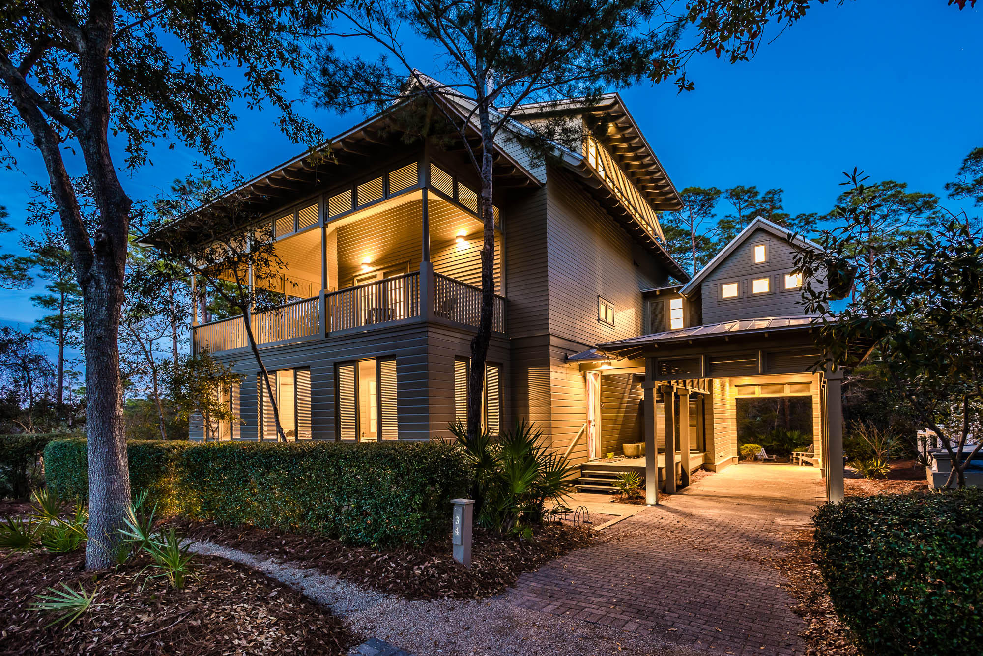 A striking and exceptional home situated on one of the most extraordinary lots in Phase 1 of Watercolor, offering stunning views of Western Lake. The home is oriented to maximize it's serene, private setting, yet it is with a close proximity to all amenities in Watercolor, and it is only seconds from Seaside. The ideal location offers the luxury of privacy and accessibility, which is nearly unparalleled in Watercolor. Outdoor entertaining is taken to the next level with over 2,000 square feet of patio space overlooking Western Lake. The first floor patio is fully screened and shuttered for privacy. The second floor is open on all sides with custom screened doors and a screened dining area. This 5 bedroom, 4 bath home would make a perfect primary residence or a lucrative investment property property. Upon entering you will first notice the gorgeous South American Kurapay hardwood floors, which are throughout the home. On the first floor you will find two spacious bedrooms with an ensuite and separate porch access. On the second floor, you will find a gourmet kitchen designed for entertaining, including a 6-burner gas range and wine cooler. The second level dining and living area are ideal for taking advantage of the breathtaking sunsets over Western Lake. Additional features include a Rais wood-burning fireplace, custom audio and lighting systems and a double bunk room. The spacious third floor Owner's Suite offers a reading nook, dual sinks and shower heads in the master bath and a spacious owner's closet with attic space. This home offers plenty of storage including a tool room attached to the covered carport and walk-in storage under the house for kayaks or other recreational equipment. The serene dock and sitting area on Western Lake that are just a few steps from the home are a must see!