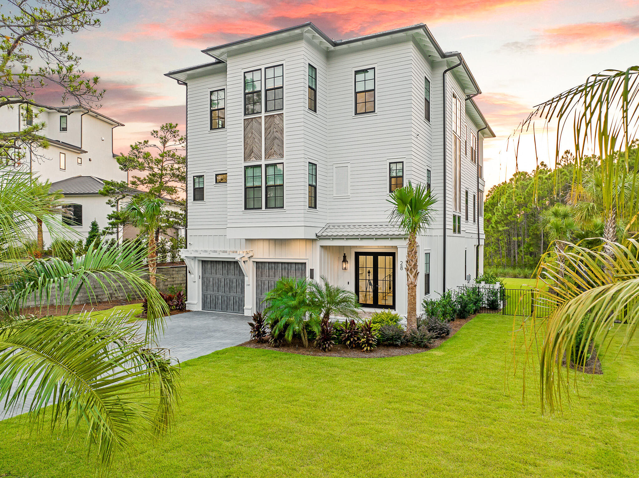 28 Loon Lake, built by Cogent Building Group and designed and furnished by Bird Dog Design Company, is a study in modern elegance and coastal serenity. Poised along the peaceful west end of 30A with deeded beach access, this newly built retreat captures the essence of refined living while embracing the laid-back rhythm of the Gulf.

The open-concept living area unfolds beneath soaring ceilings, where natural light spills through expansive windows and dances across sleek finishes. The chef's kitchen blends seamlessly into the dining and living spaces, anchored by a striking wet bar that invites evenings of effortless entertaining. Every element, from the curated lighting to the layered textures, reflects a thoughtful approach to both style and comfort. Five bedrooms, including a custom bunk room, offer a harmonious mix of privacy and flexibility, while each bath is elevated by intricate tilework and modern fixtures, creating spa-like sanctuaries throughout the home.

Beyond its walls, the landscaped backyard reveals a private pool, a tranquil escape for slow mornings or lively afternoons under the Florida sun. Surrounded by the beauty of its natural setting and steps from sugar-white sands, this property offers a rare blend of sophistication, relaxation, and coastal charm.

With its balance of architectural precision and inviting warmth, 28 Loon Lake is more than a residence. It is an expression of luxury living on 30A.